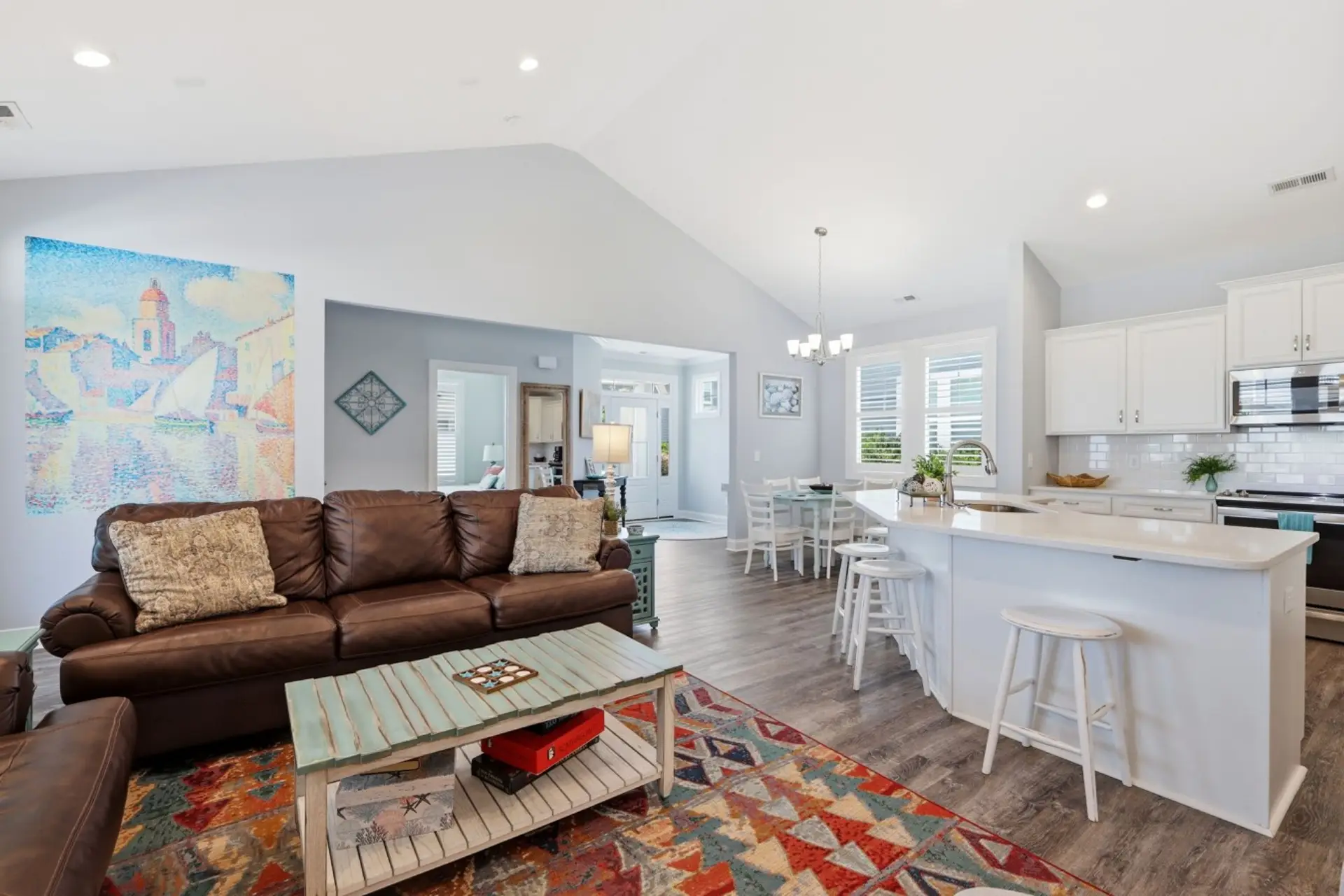 Enjoy seamless indoor living in this bright open-concept space featuring comfortable seating, a spacious kitchen, and dining area