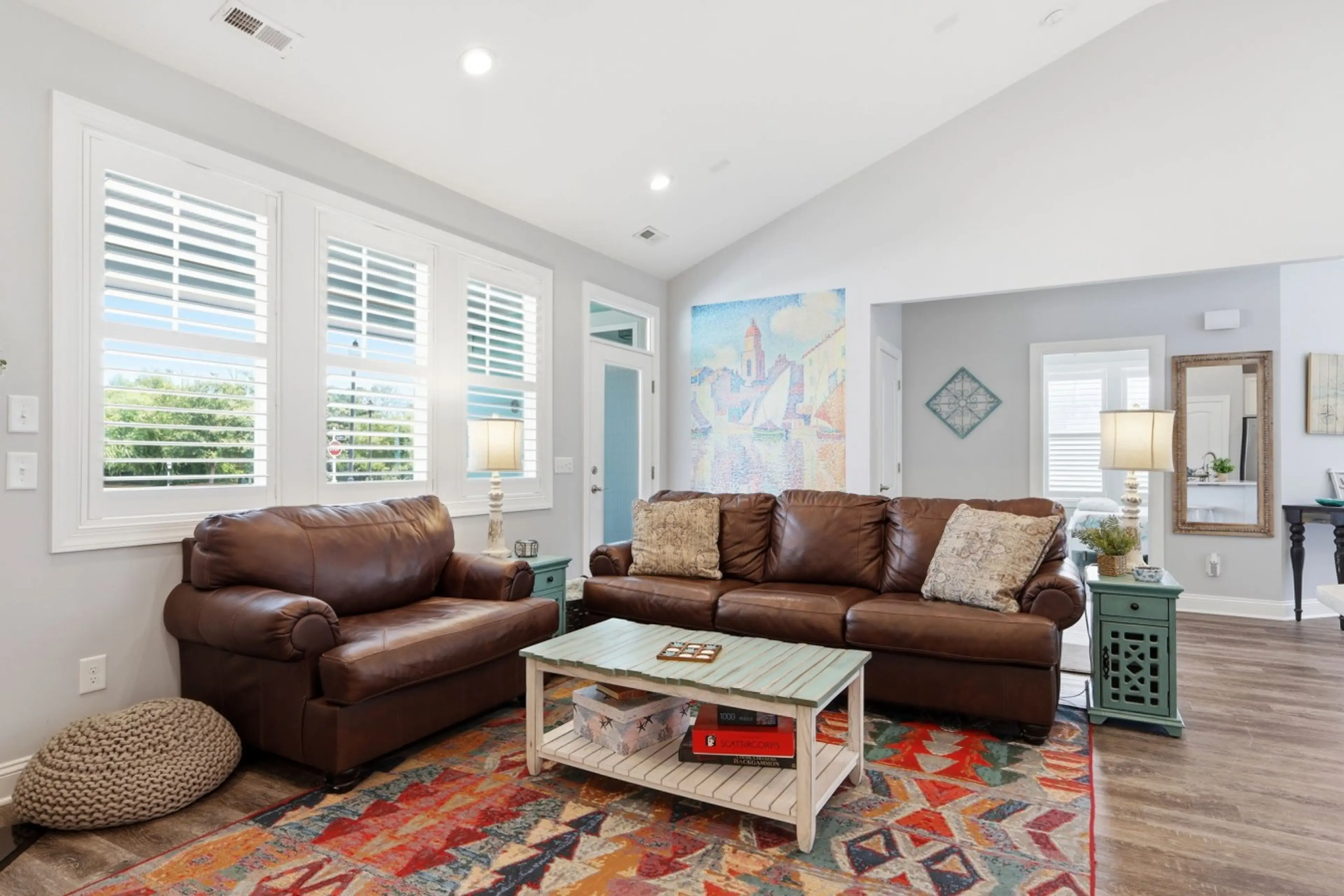 Gather with family and friends in this bright, comfortable living room featuring ample seating and an open-concept layout