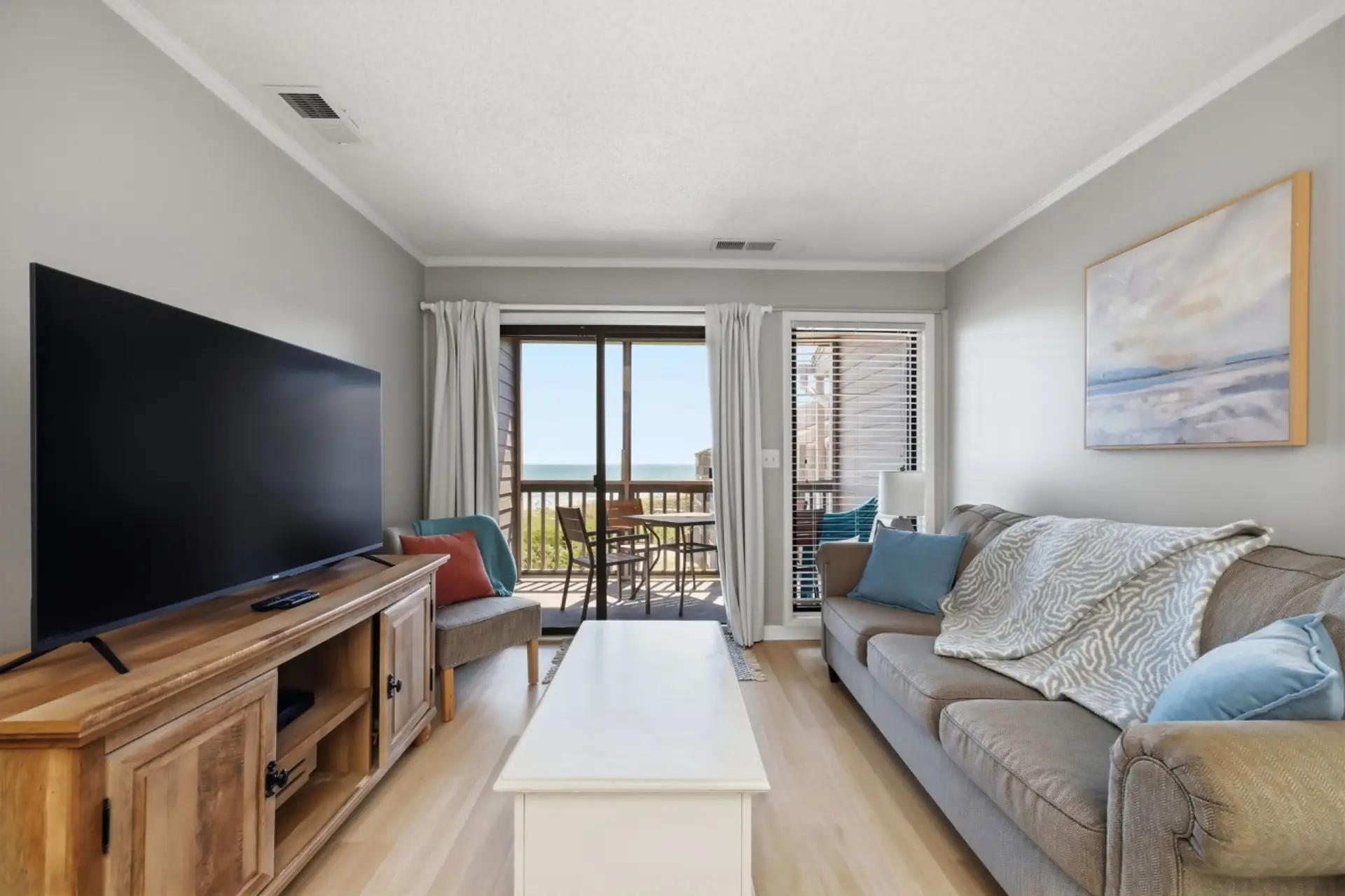 Unwind in the bright living room with a large TV and beautiful ocean views from the private balcony