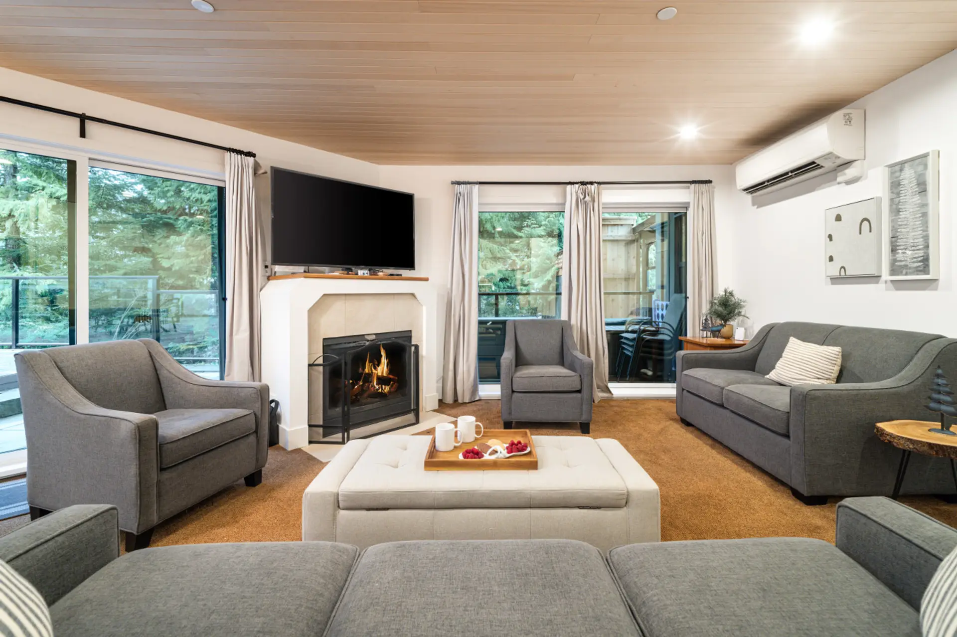 Cozy, sunken living room with comfortable seating, a gas fireplace, Smart TV, and air conditioning — a perfect spot to unwind year-round