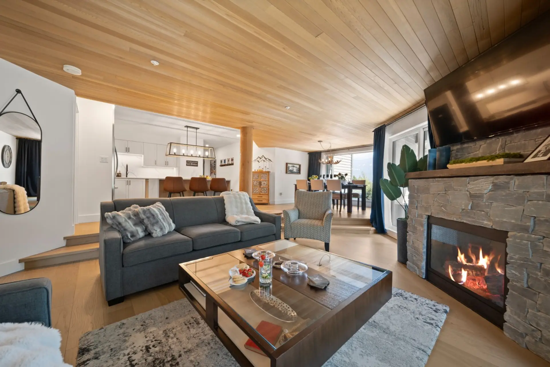 Spacious open-concept living area with a cozy gas fireplace, AC and plenty of room to relax.