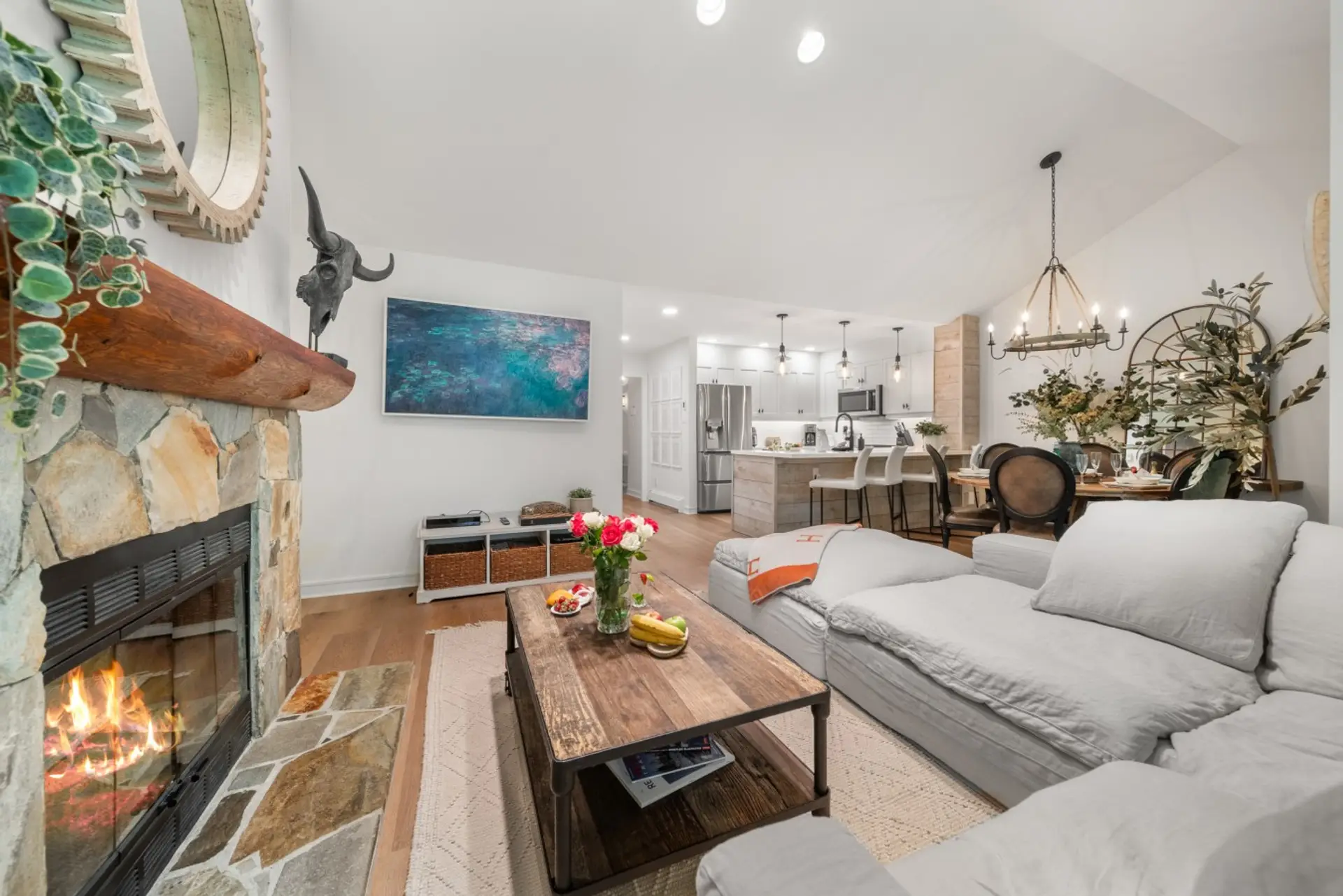 Bright open-concept living area with fireplace and comfortable seating.