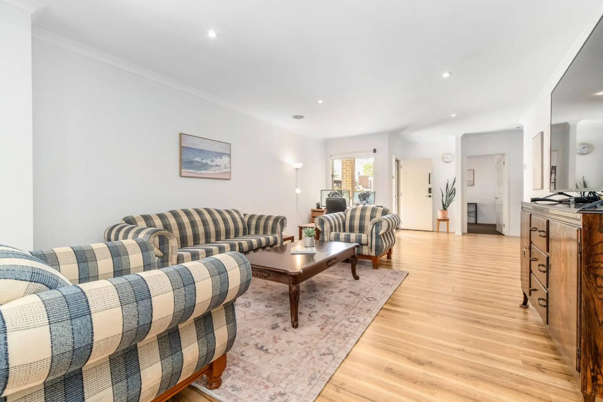 Open plan living room with 70" Smart TV, Air-conditioning, ducted heating and an office space down near the entrance.