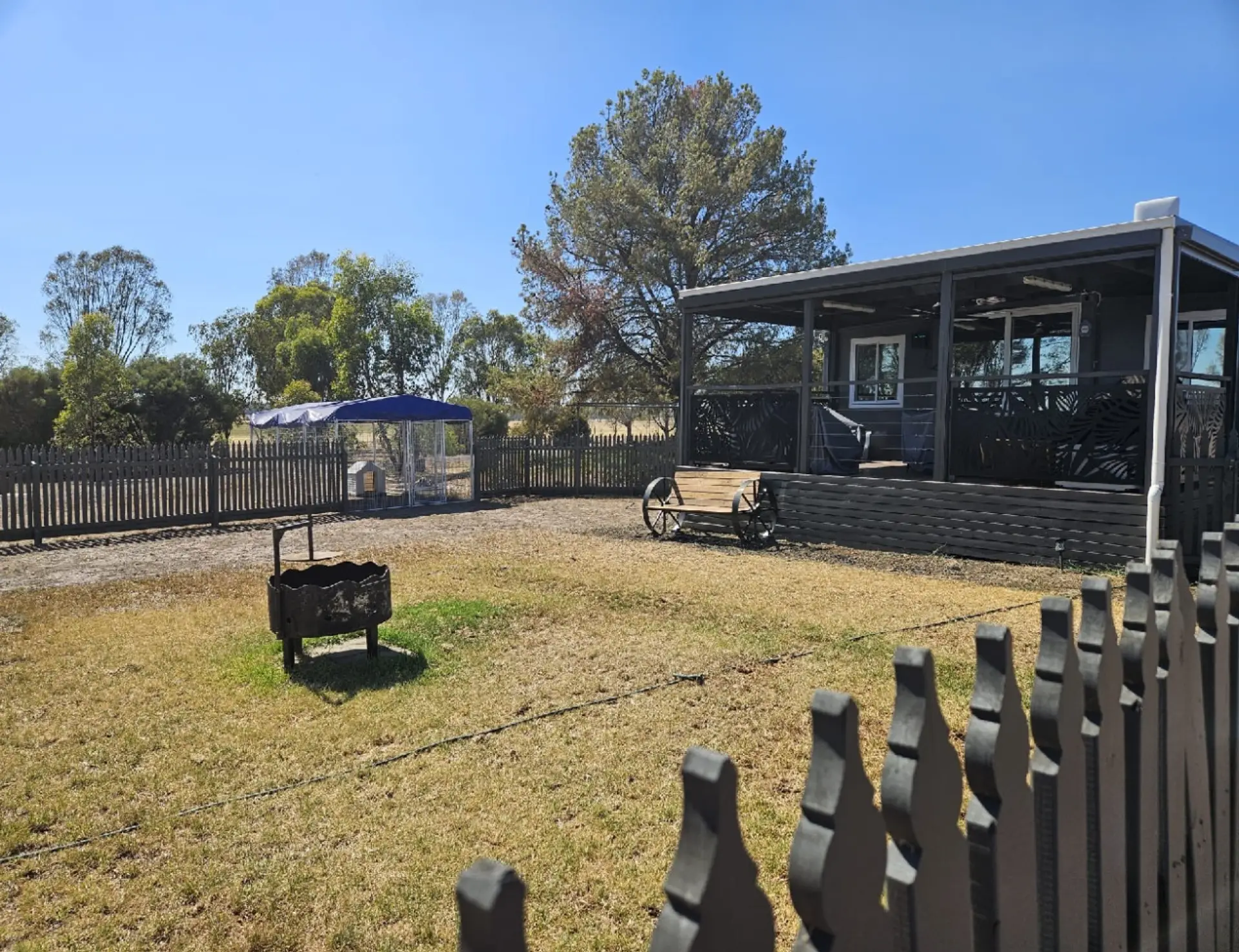 Fully Fenced yard with dog cage if required