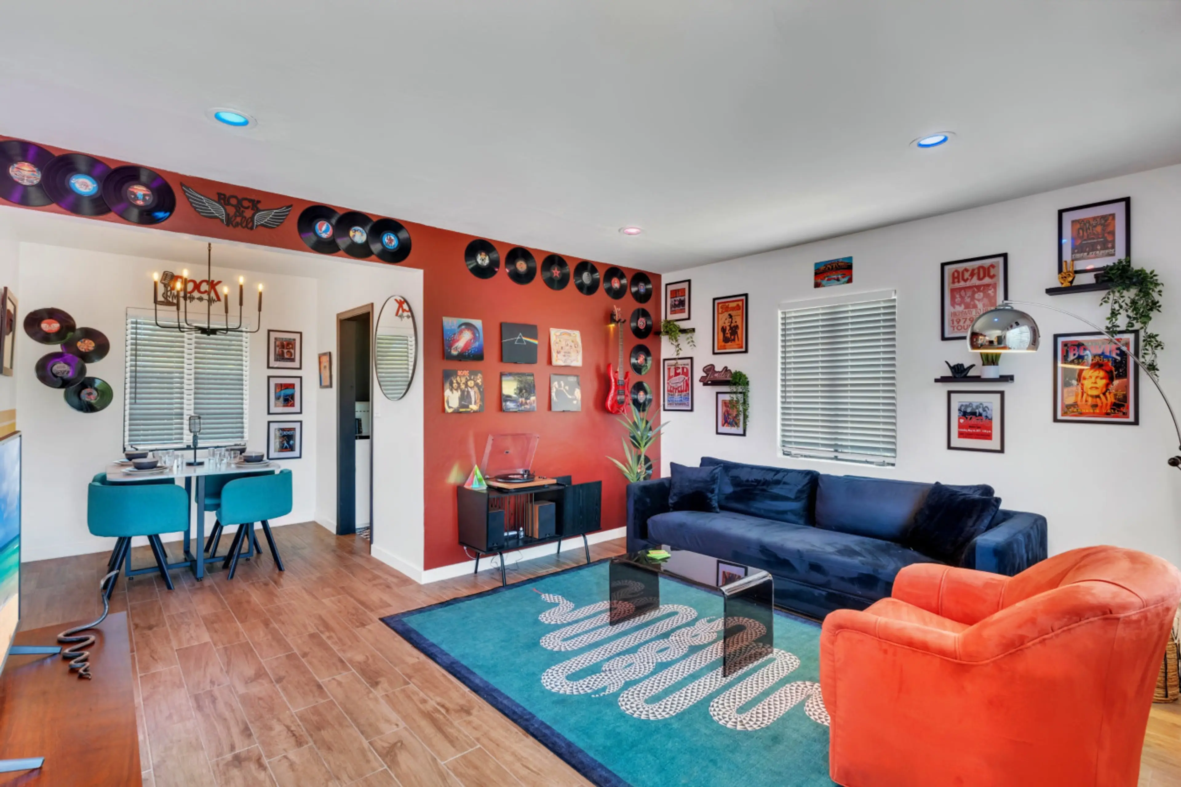 Queen pull-out sofa for extra comfort, vintage record player with classic rock legends, and a 65-inch Smart TV for the perfect movie night setup.