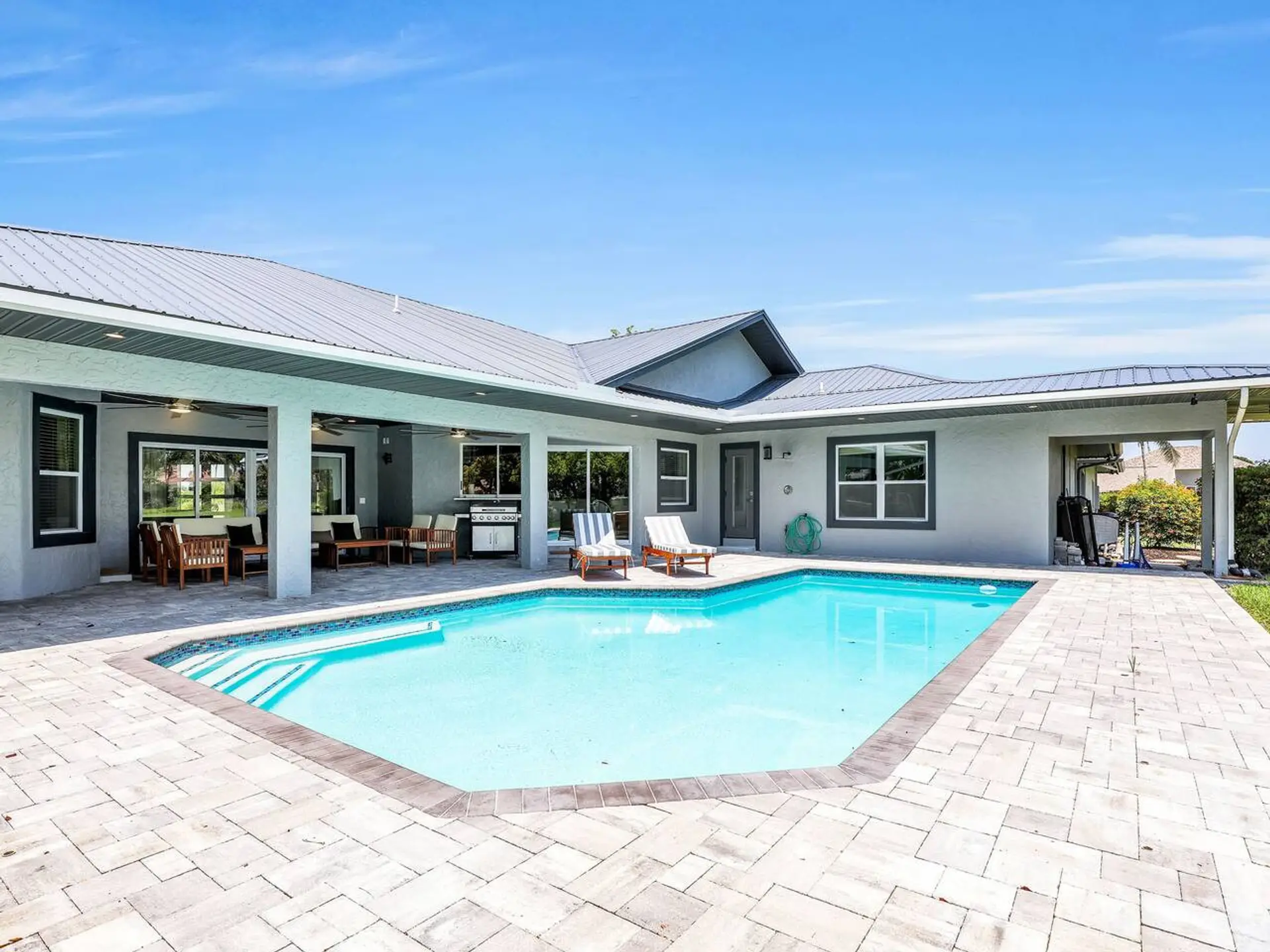 View of the pool and patio area from the backyard