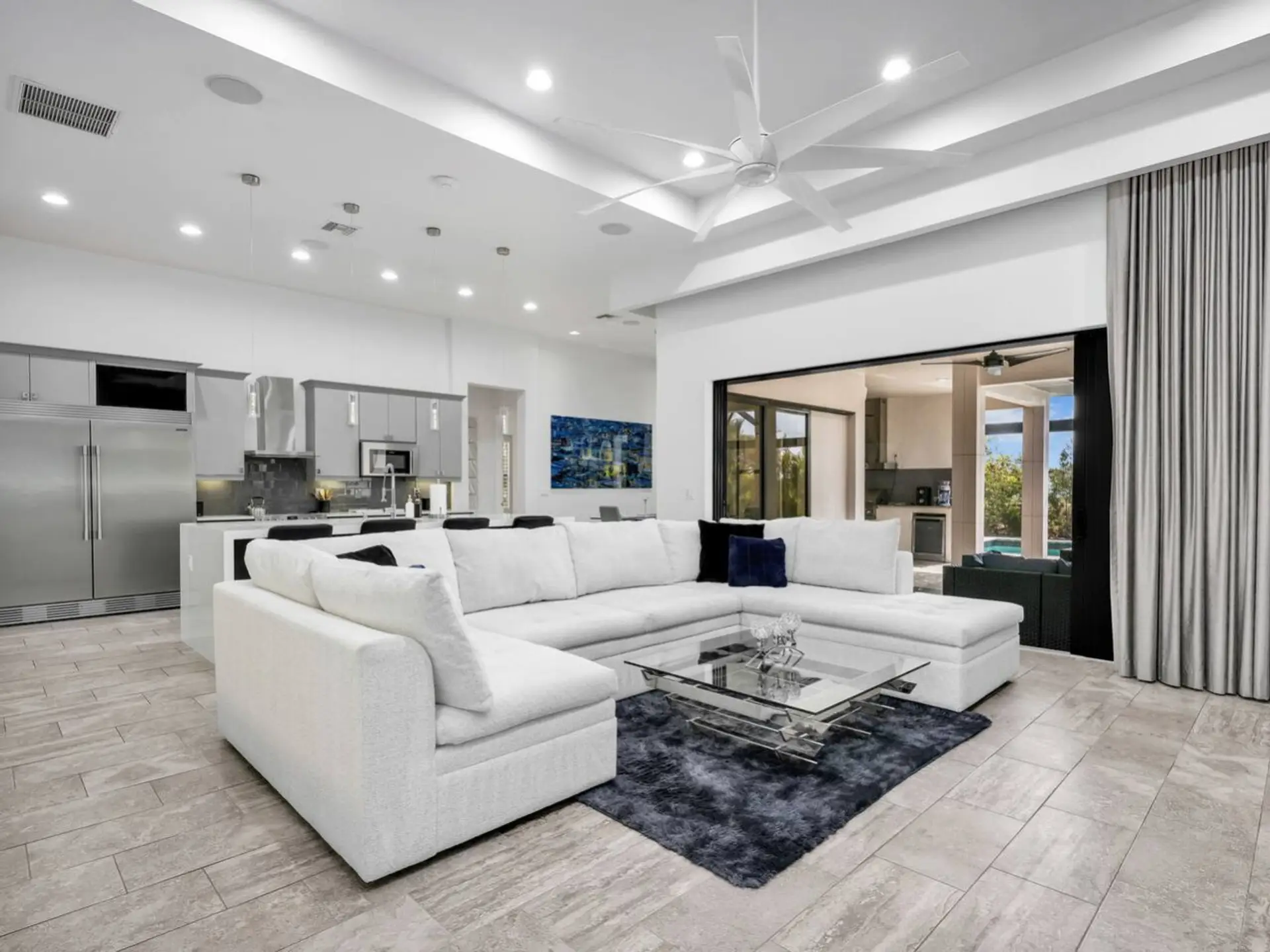 Relax in the bright open living area, designed for gathering, dining, and enjoying effortless access to the lanai.