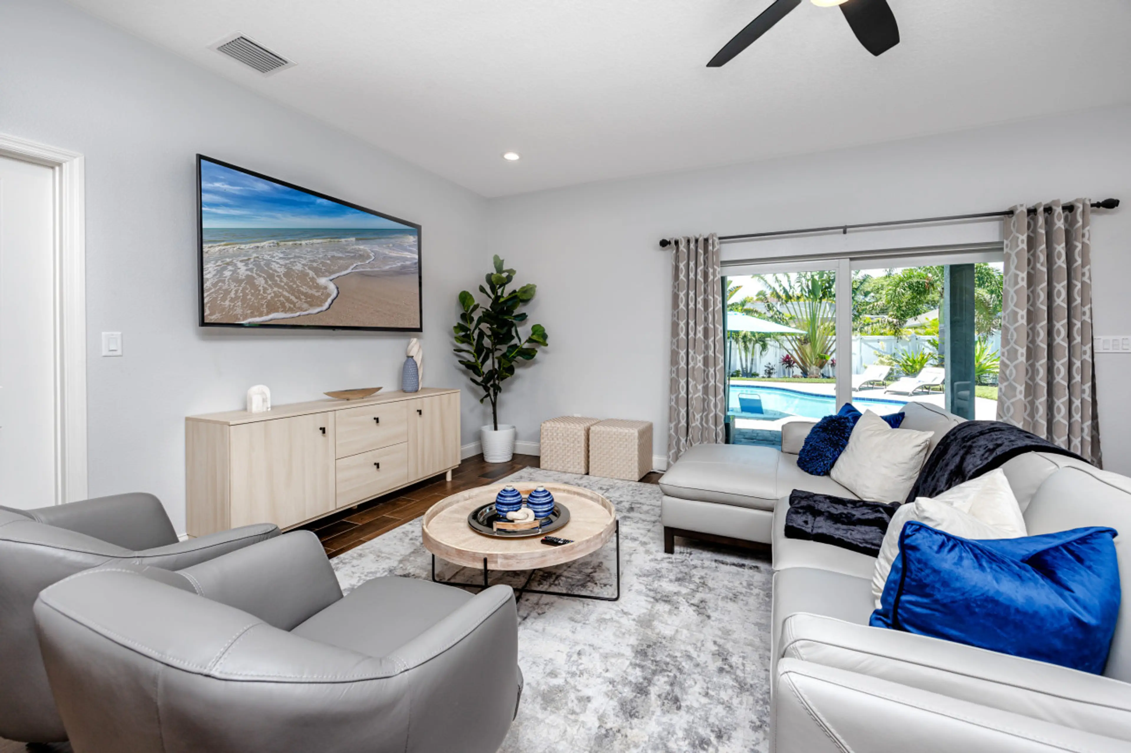 Living area with huge flat screen TV and patio access