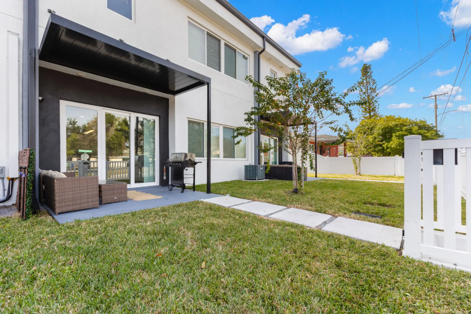 Back patio with outdoor seating and gas grill