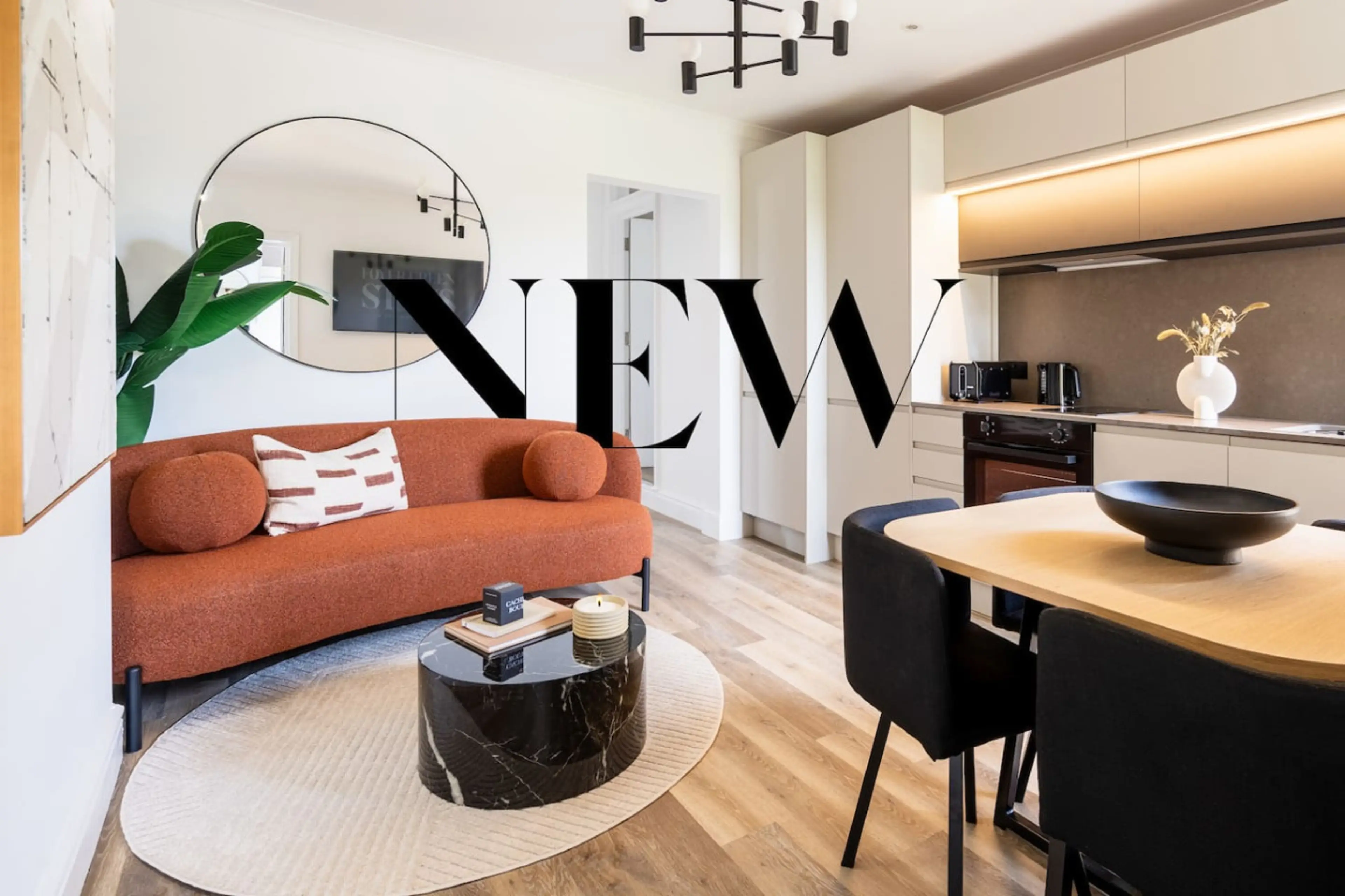Step into a bright and cheery living room with a modern sofa just begging for a lazy afternoon. The open-plan kitchen means no one has to miss the conversation while cooking (or at least pretending to).