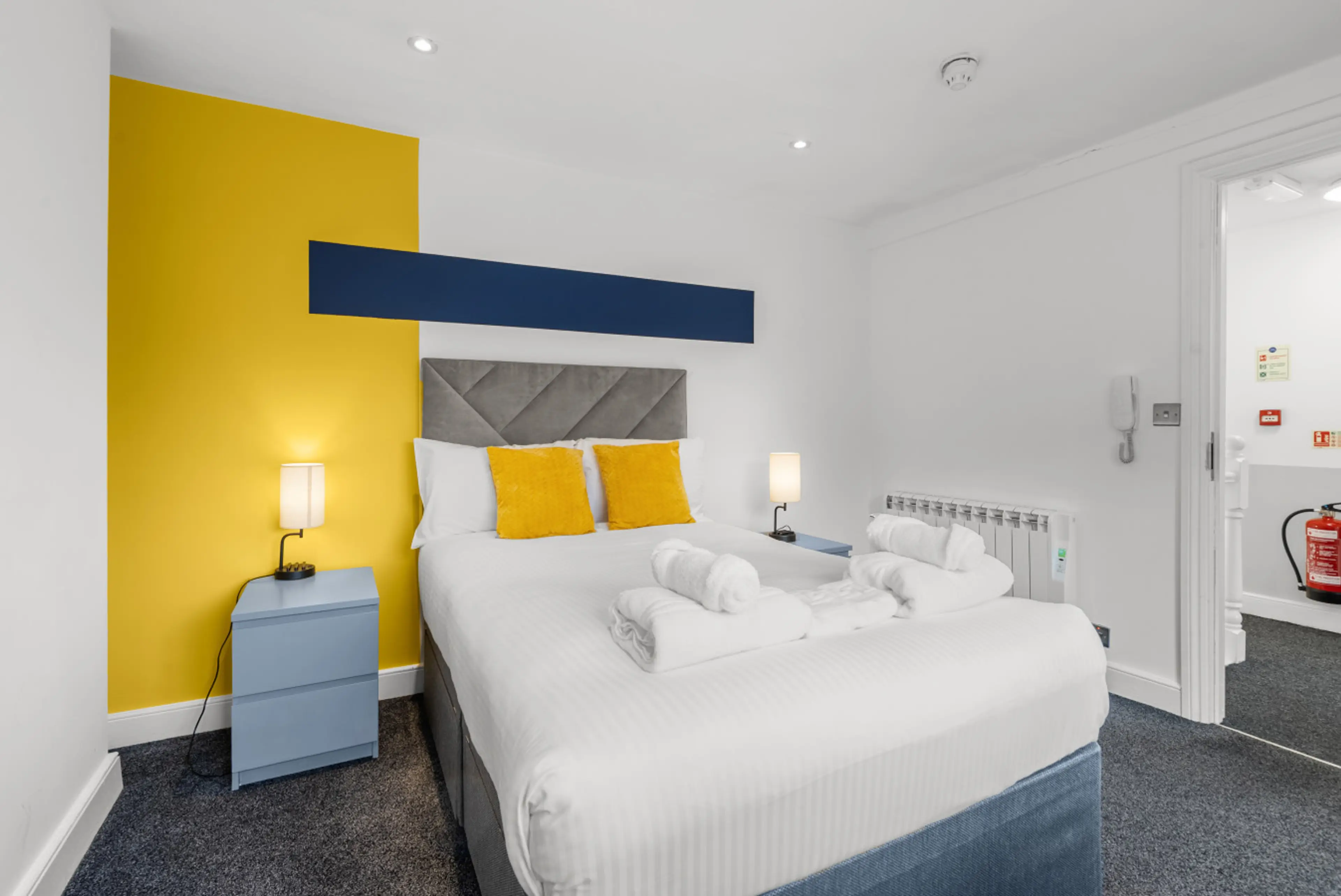 Room 5 – 2nd Floor Bed & Door - Welcoming bedroom entrance leading into a cozy and relaxing guest space.