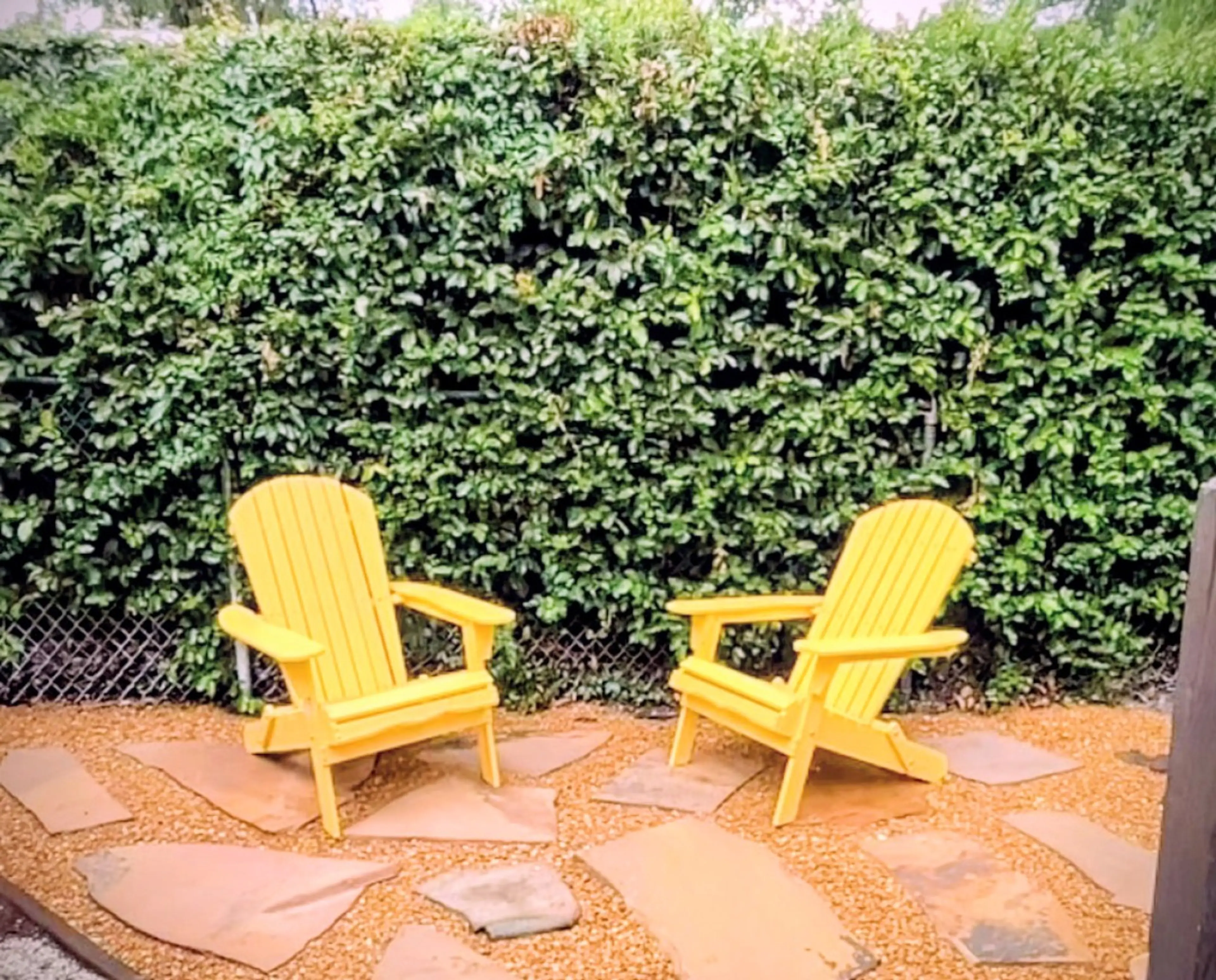 Sunbath in style lounging in the wooden Adirondack chairs in the private flagstone hard garden.