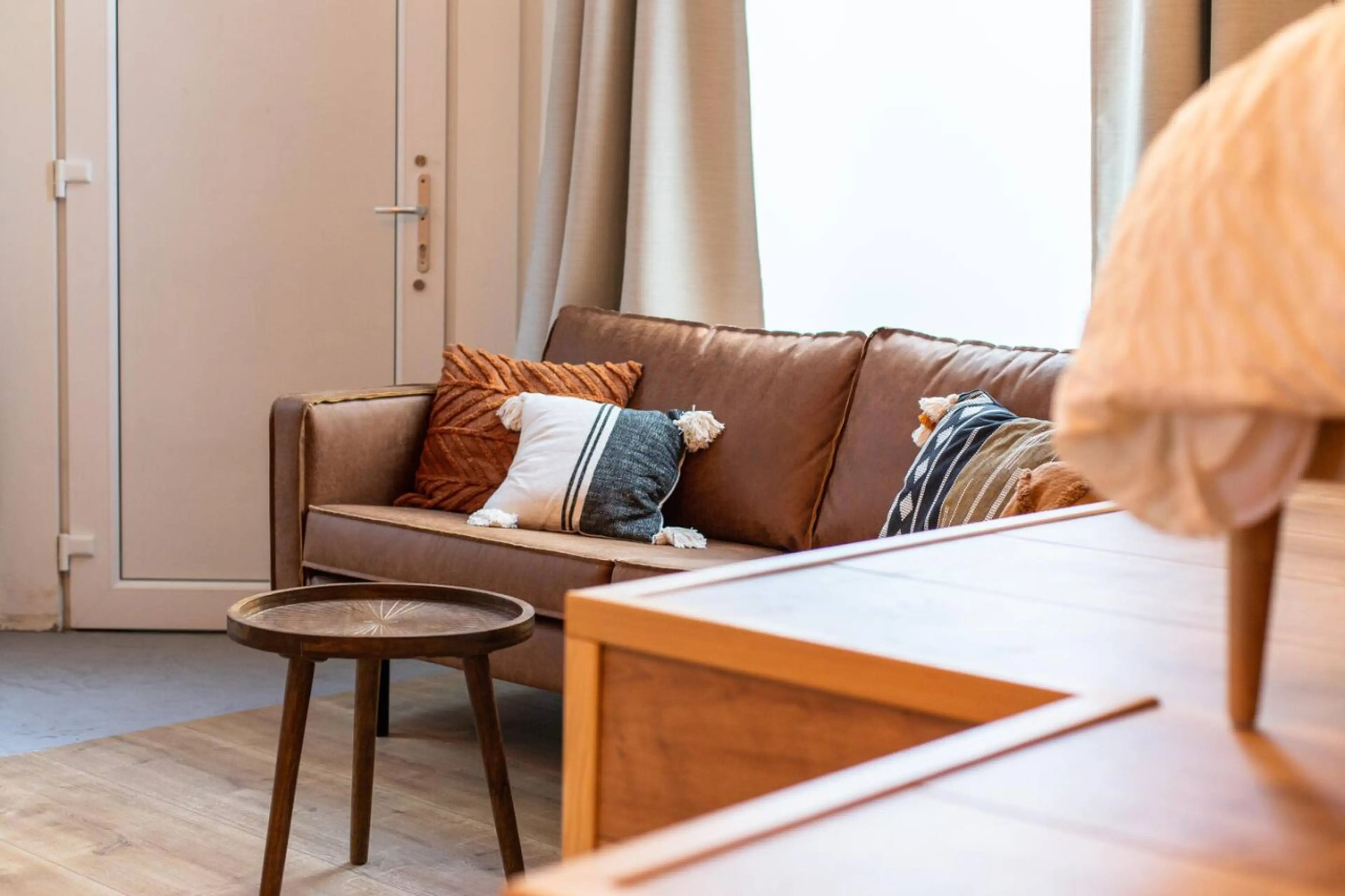Inviting living area w/ sofa seating, soft textiles & warm lighting for unwinding