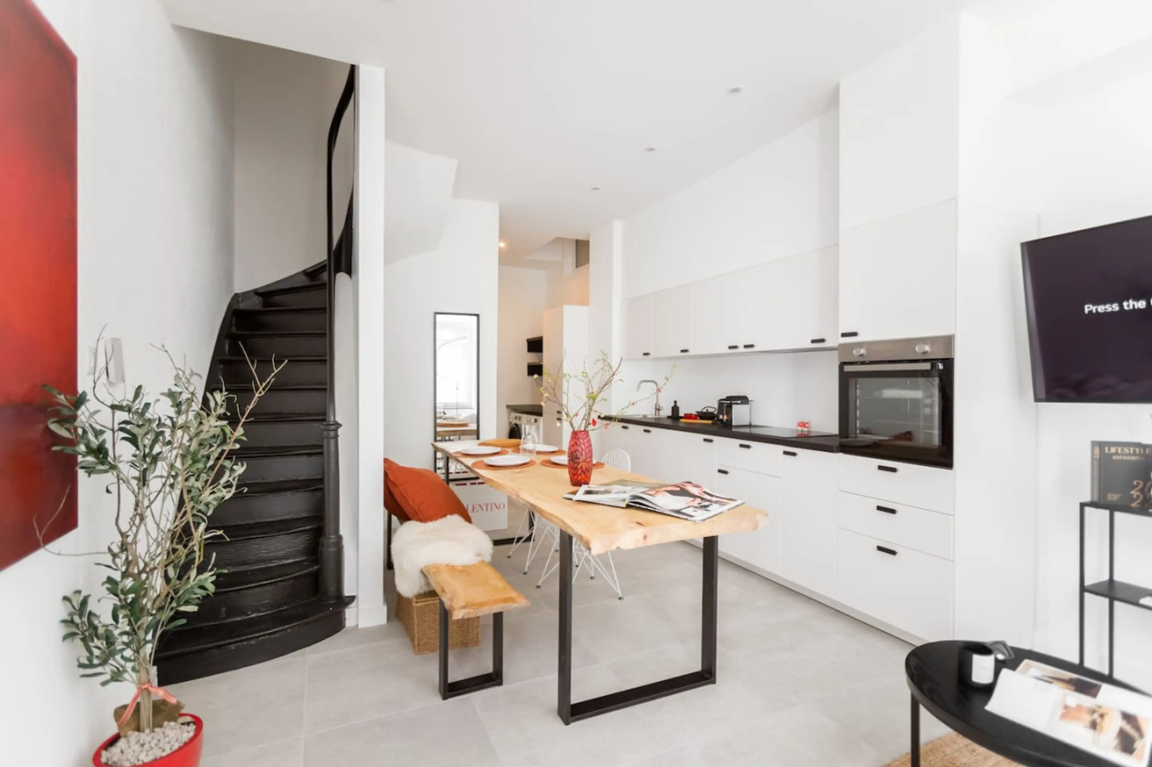 Open kitchen w/ island seating & dining setup, perfect for casual meals & conversation