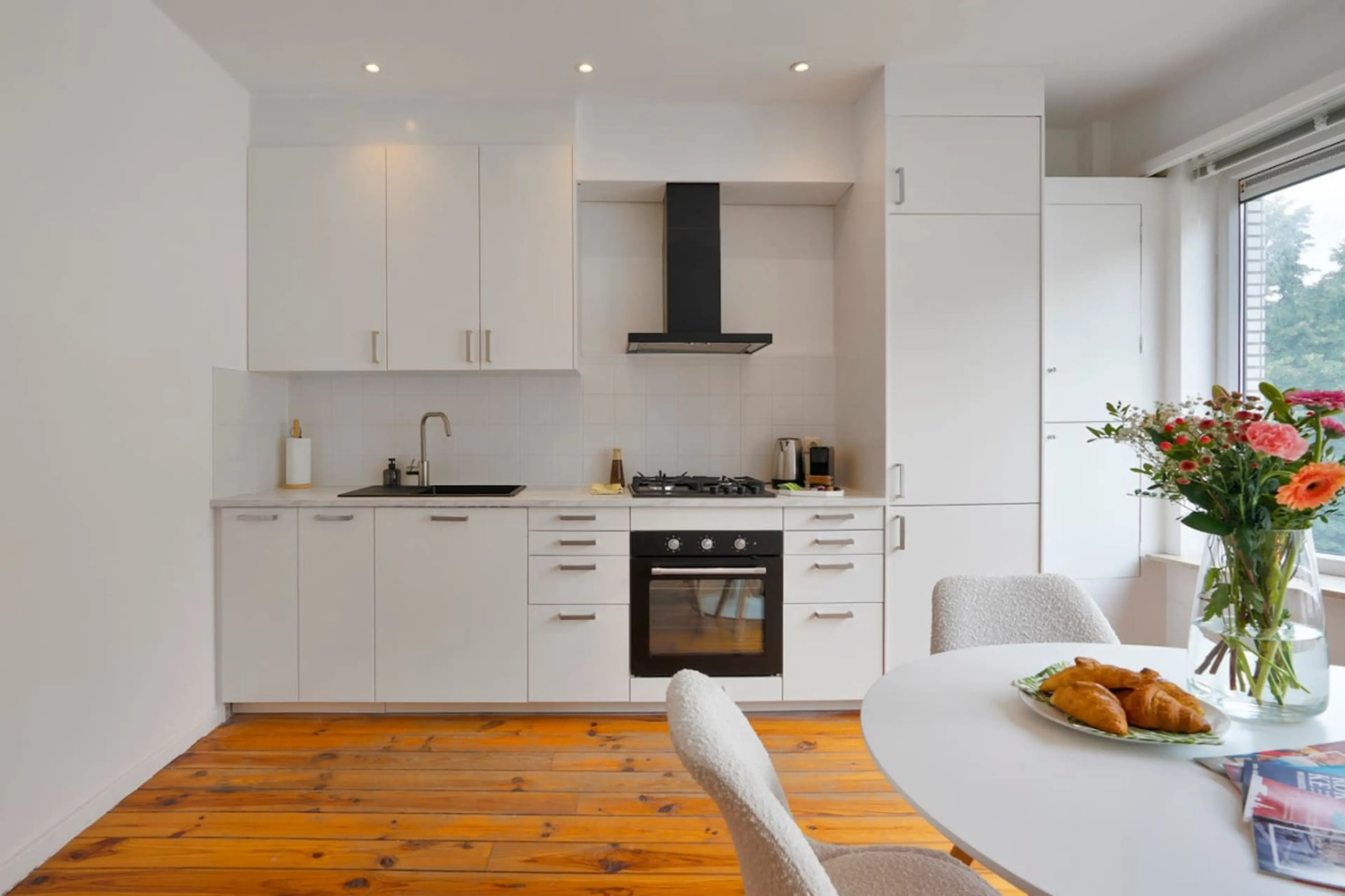 Bright modern kitchen w/ sleek cabinets, oven & window light for easy everyday cooking