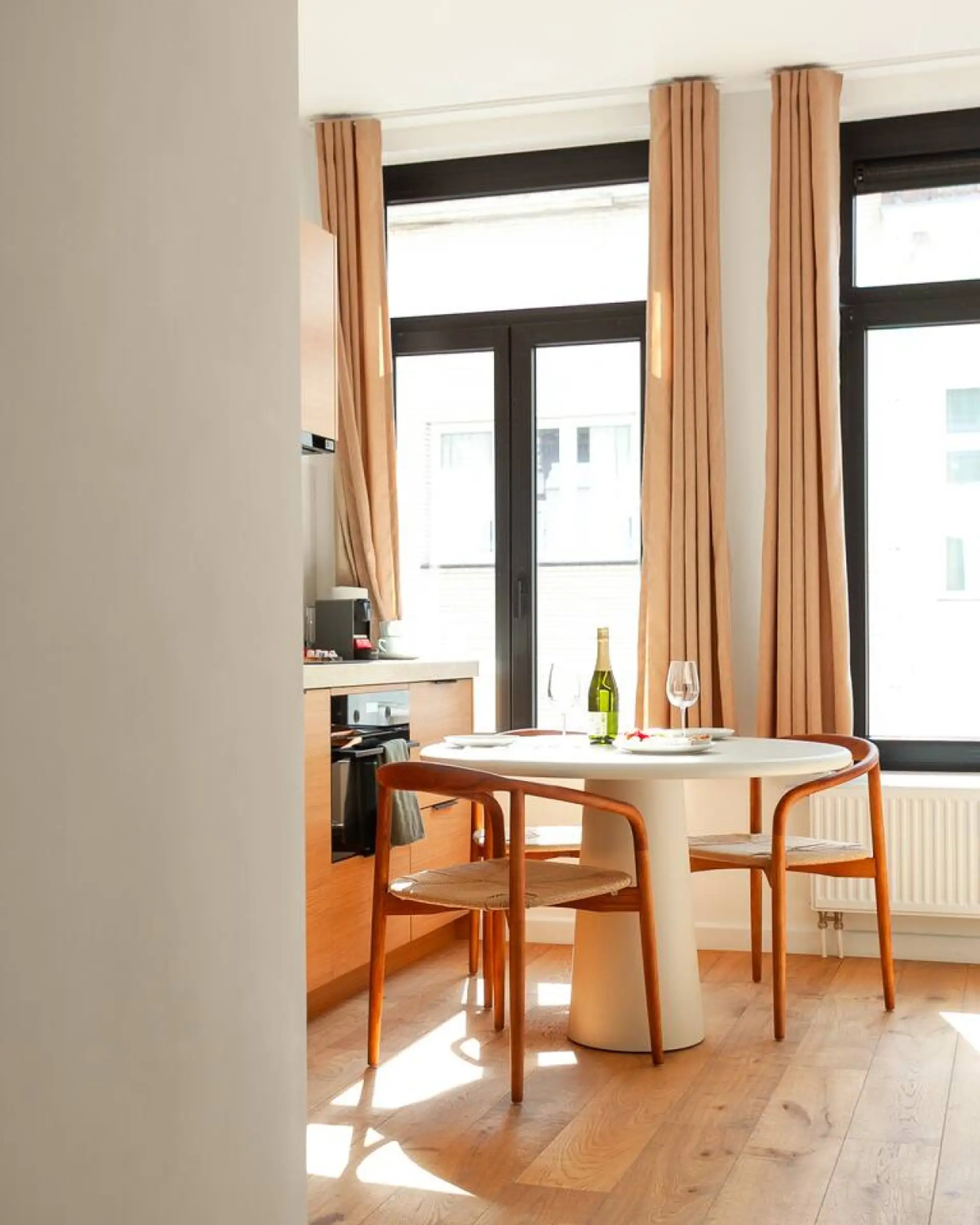 Intimate dining nook by the window, perfect for slow breakfasts or evening wine