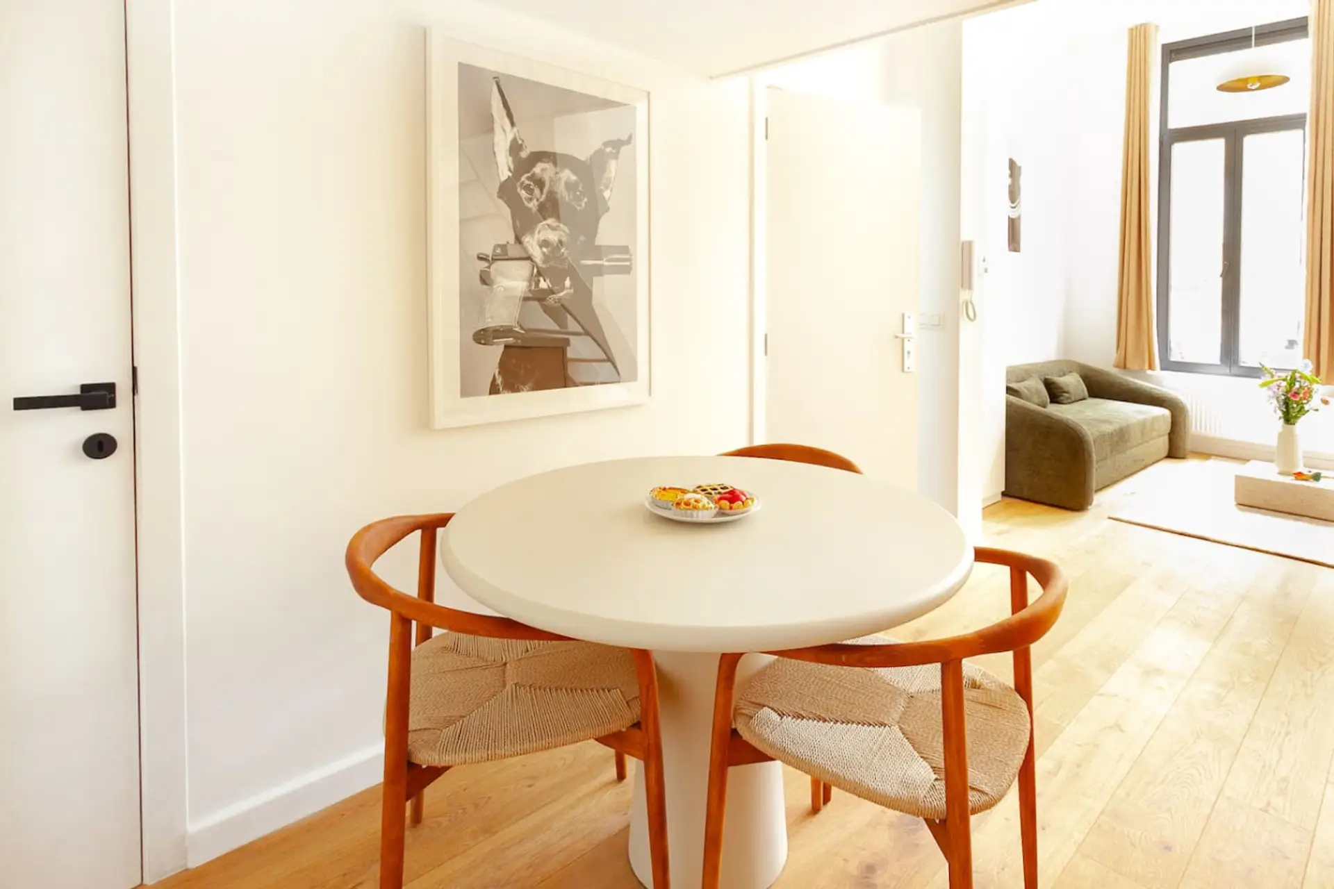 Intimate dining nook w/ round table set beside sunlit windows for easy meals