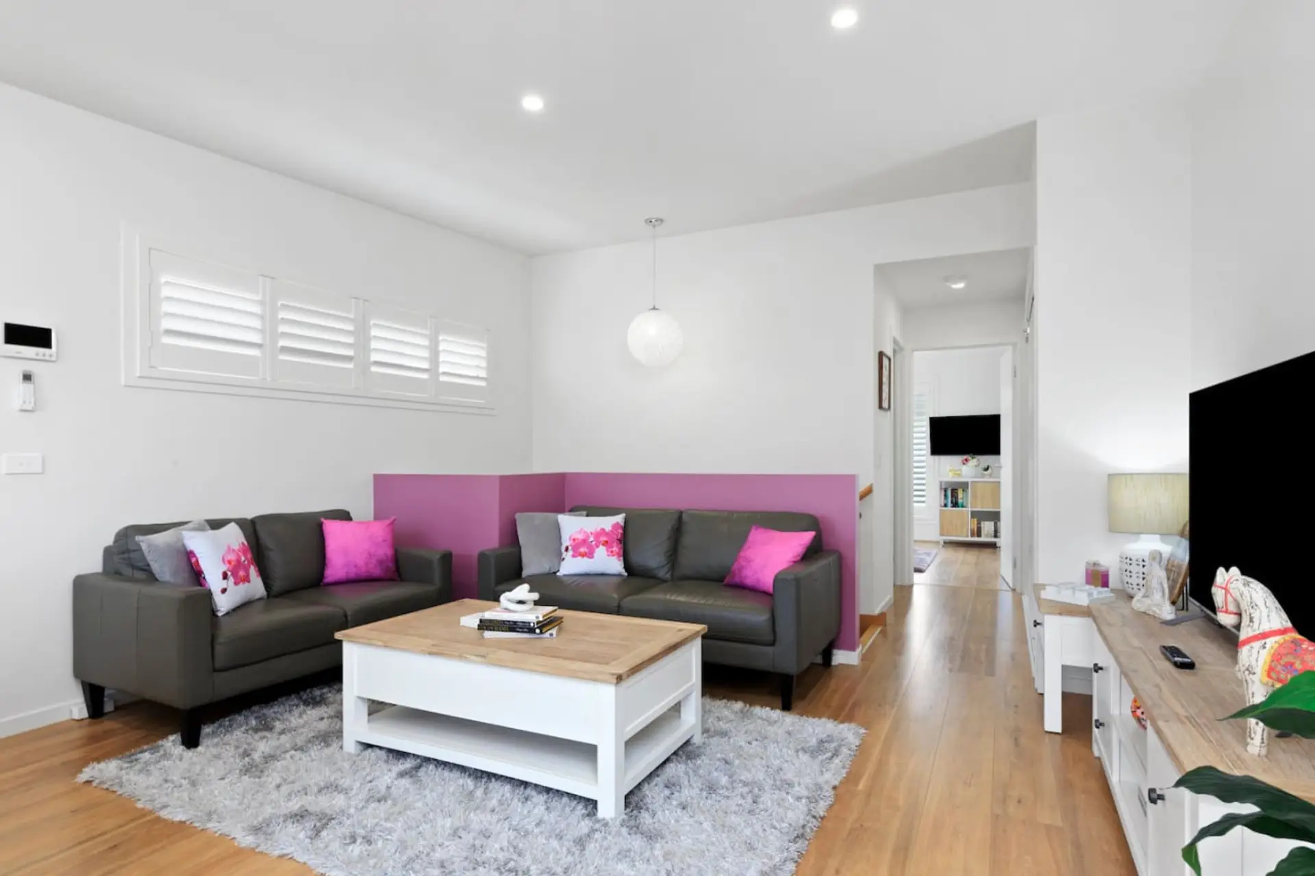 🛋️ Upstairs living area with sofa, TV, and natural light