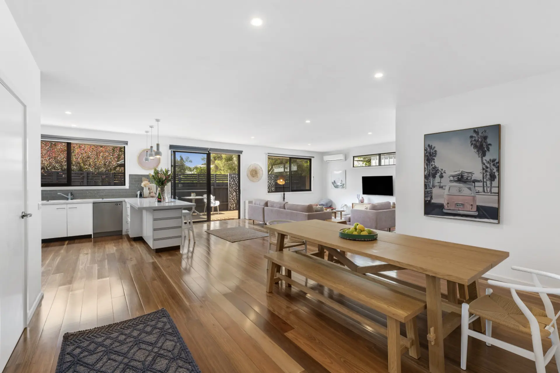 Bright open living space connecting dining area and modern kitchen