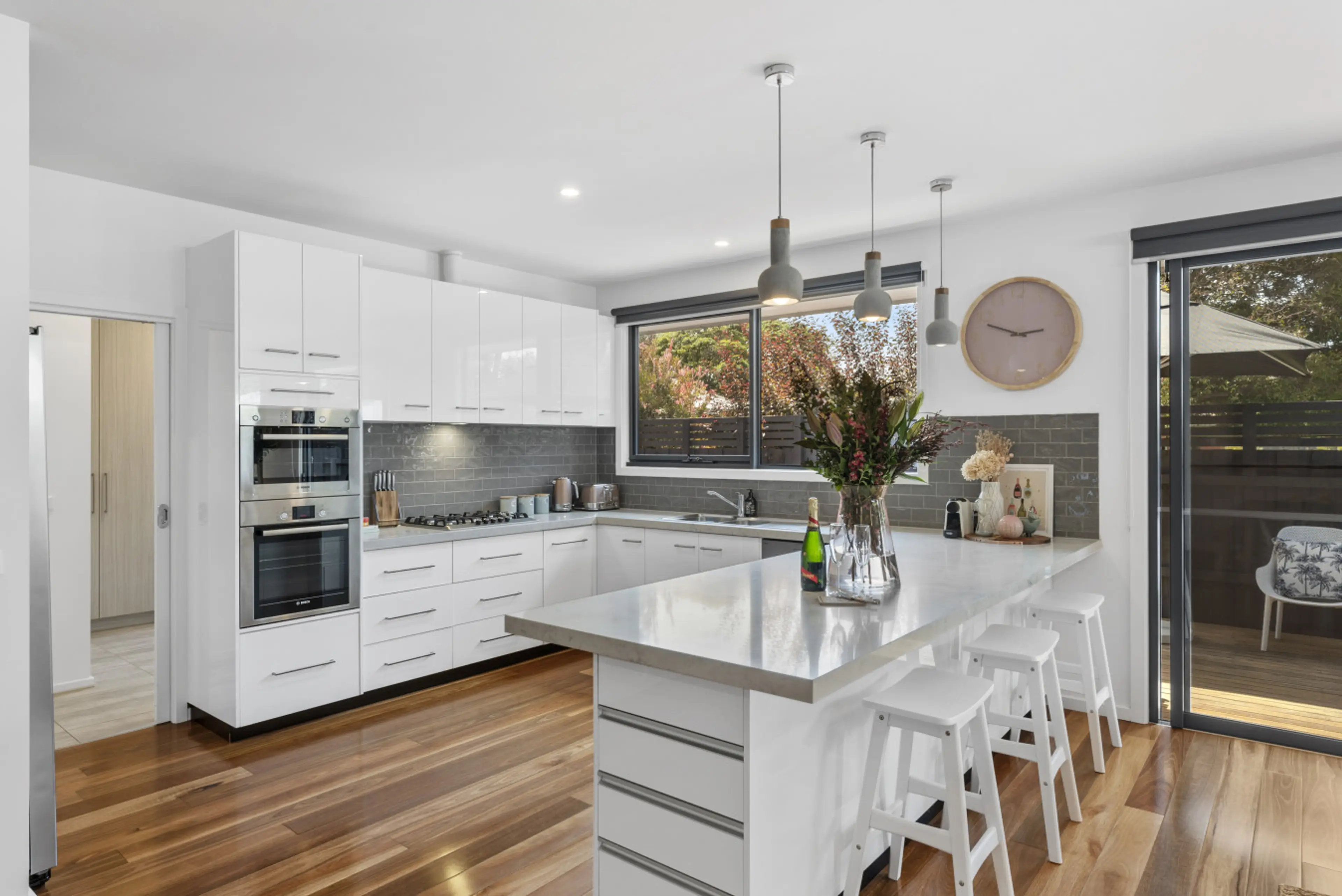 Bright kitchen with island seating and quality appliances