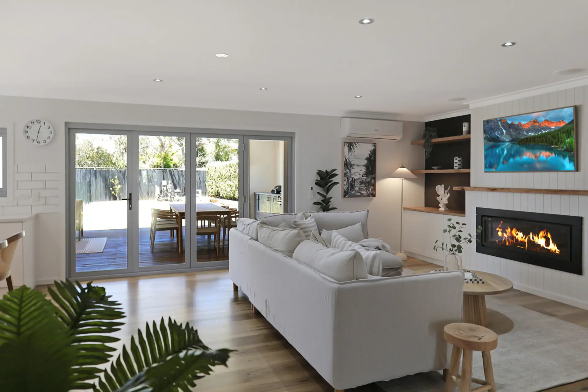 Open-plan living with fireplace flowing to outdoor dining area