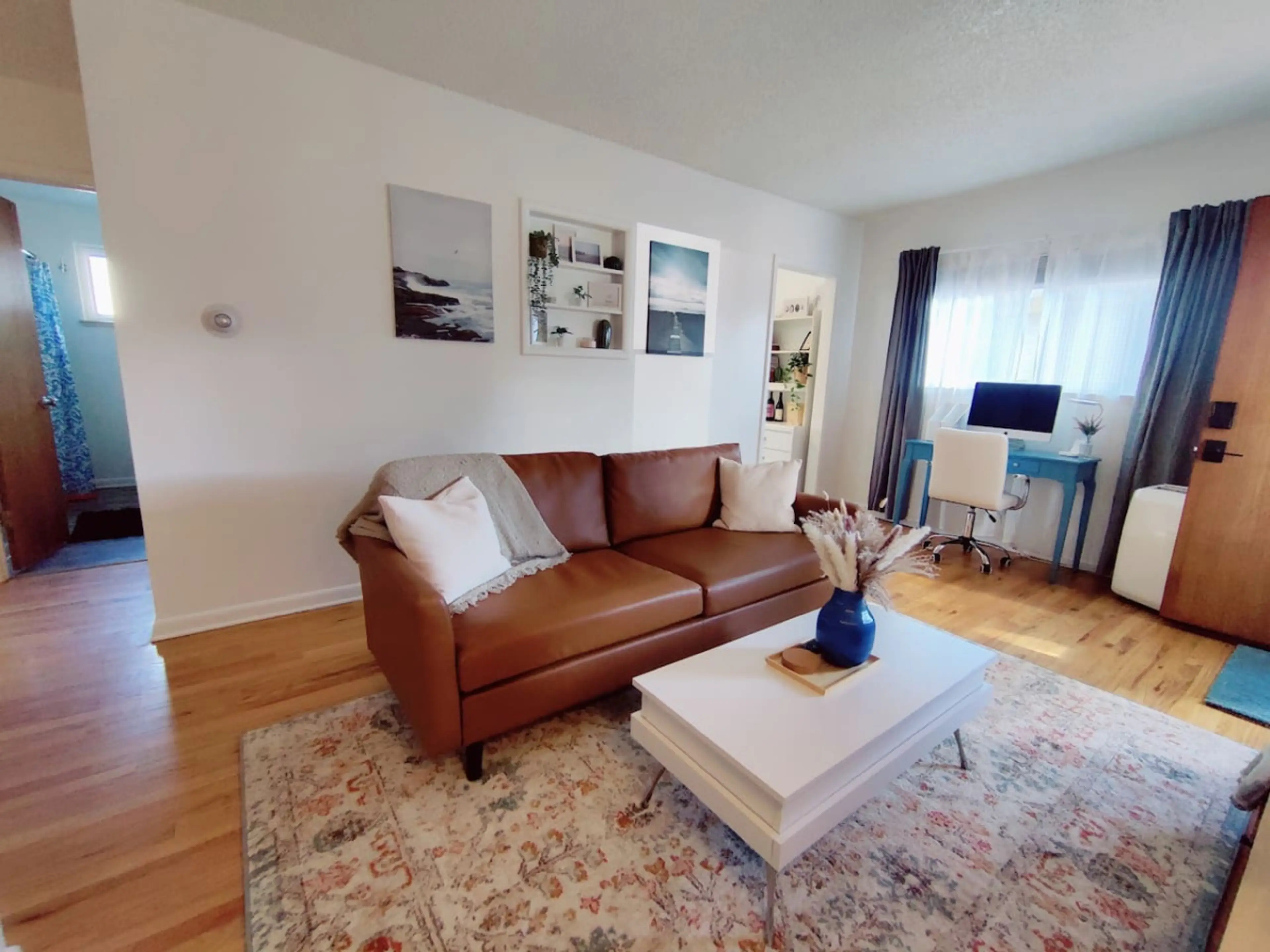 The inviting couch and chic coffee table create an ideal setting for relaxation or entertaining friends
