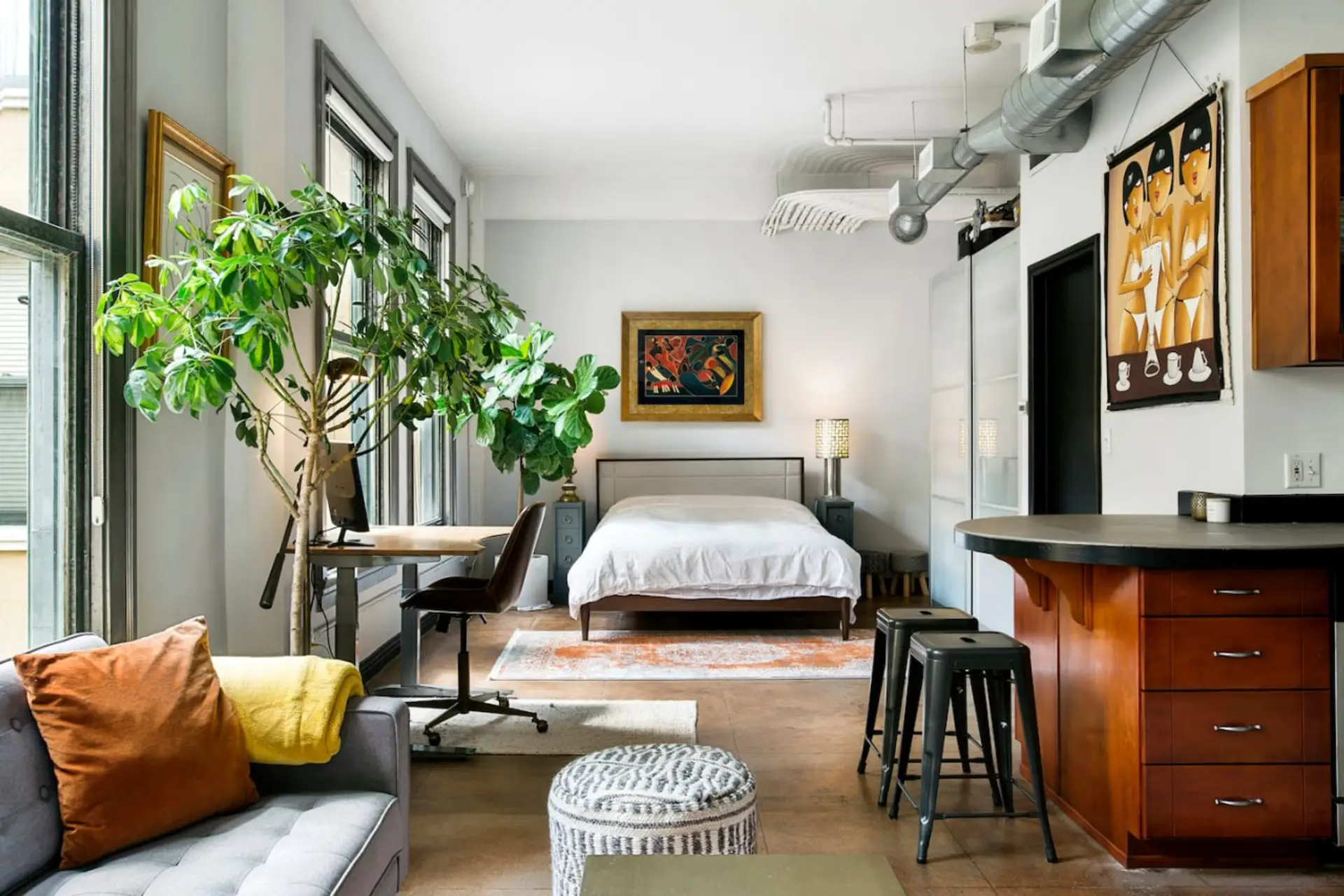 Unwind in this stylish studio featuring a plush queen bed, chic décor, and a cozy lounge space.