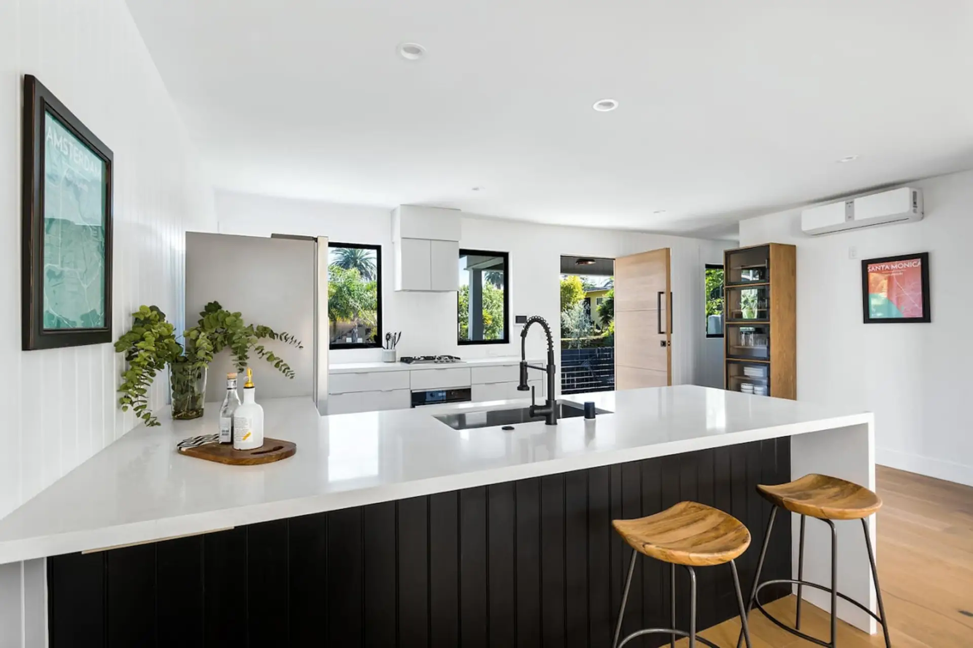 Spacious, Elegant and Pristine Kitchen with Sleek Countertops and Additional Seating