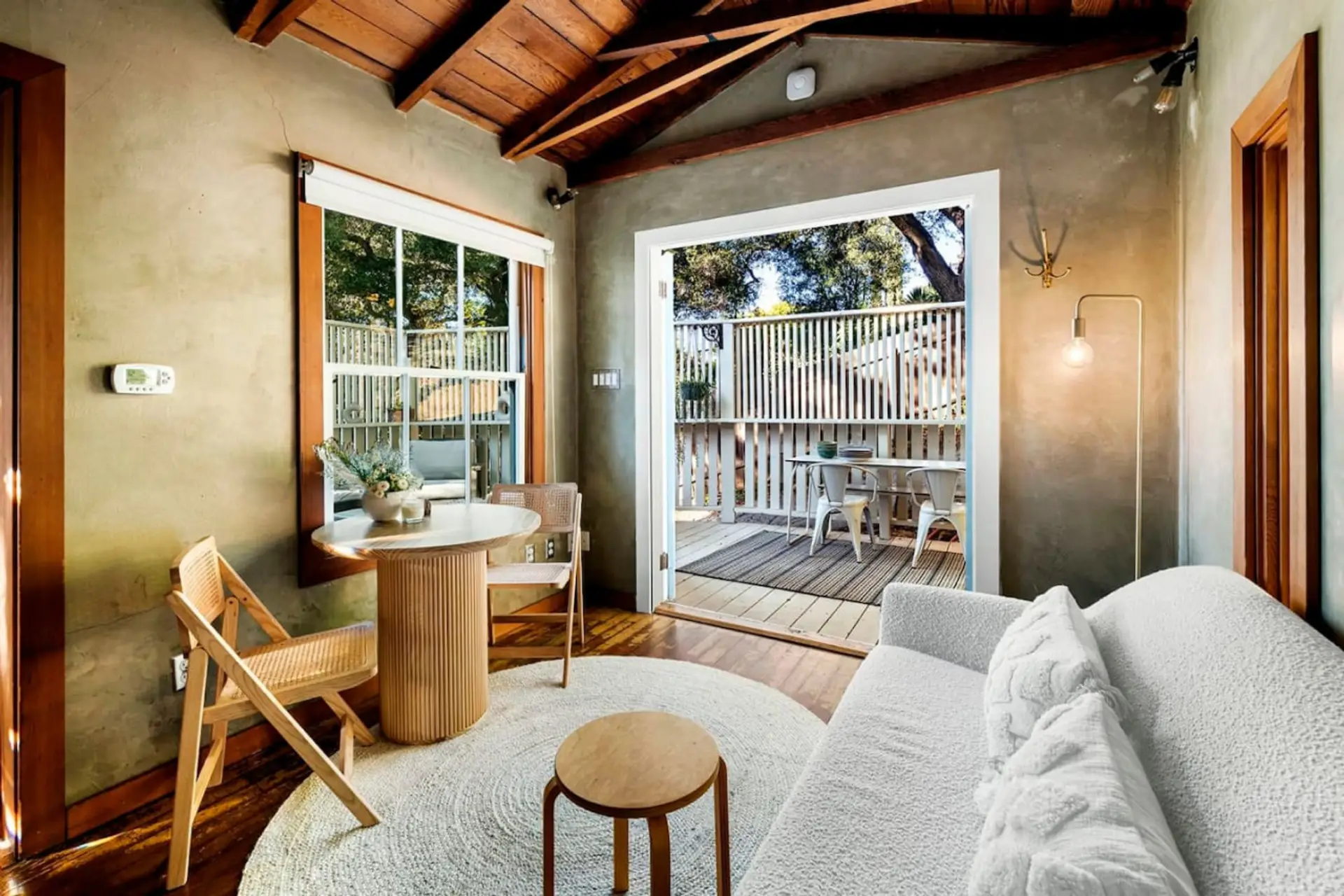 This inviting living and kitchen space opens up to a tranquil private patio for a perfect retreat.