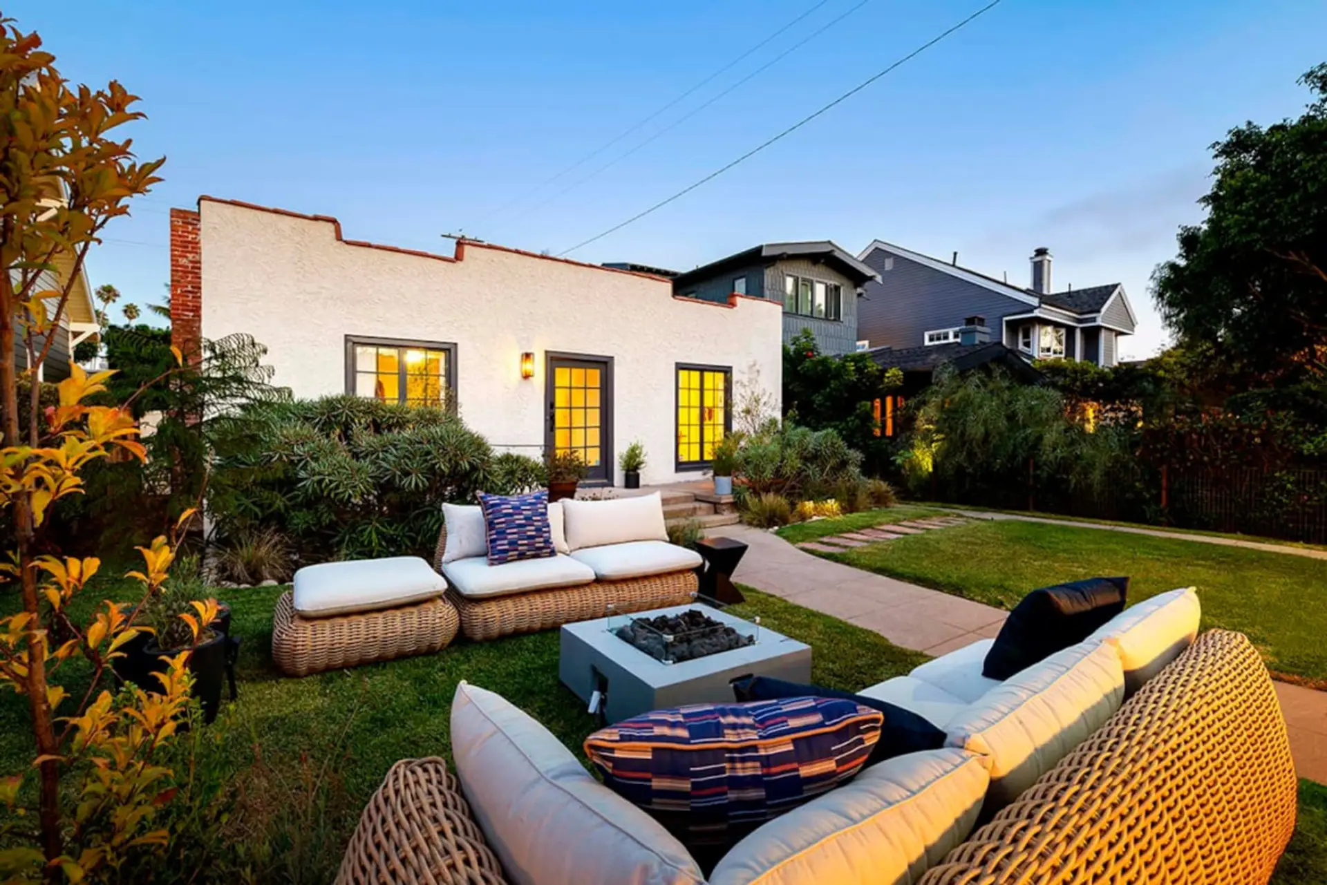 Spacious and serene—this fenced backyard with a comfy sofa is ideal for unwinding.