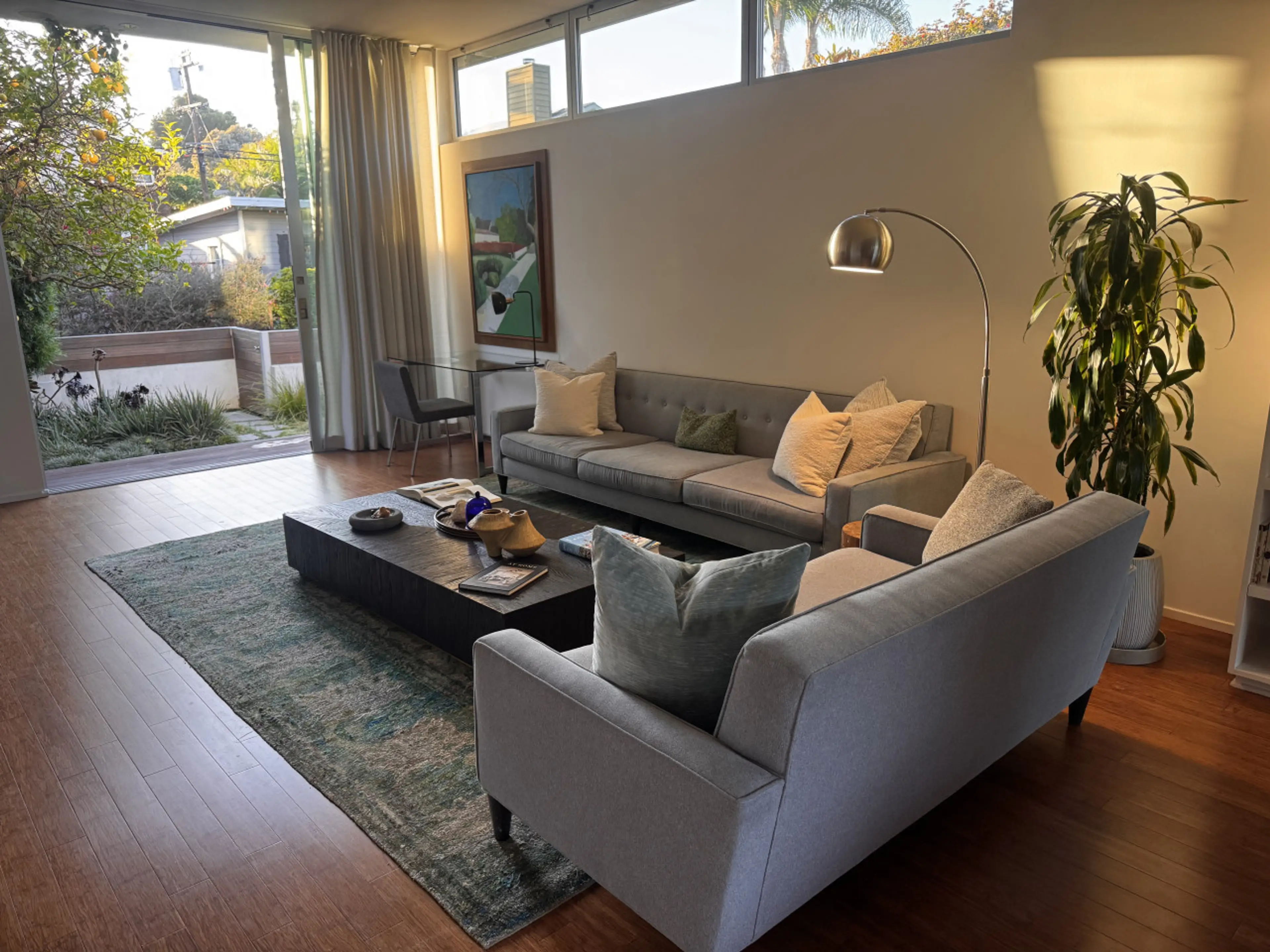 Relax in a light-filled living room with garden views