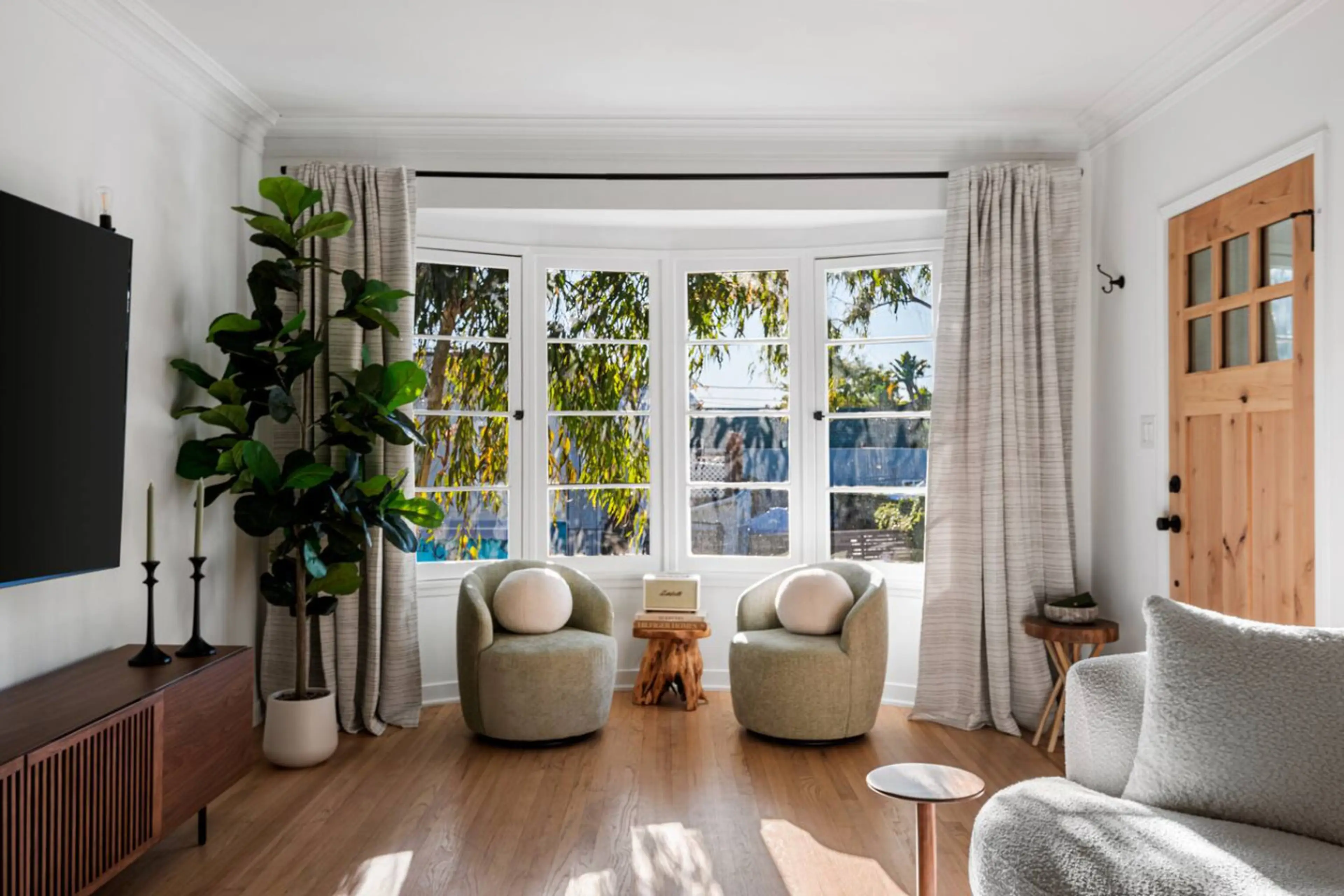 Modern living room with a cozy gray sofa and entertainment-ready TV.