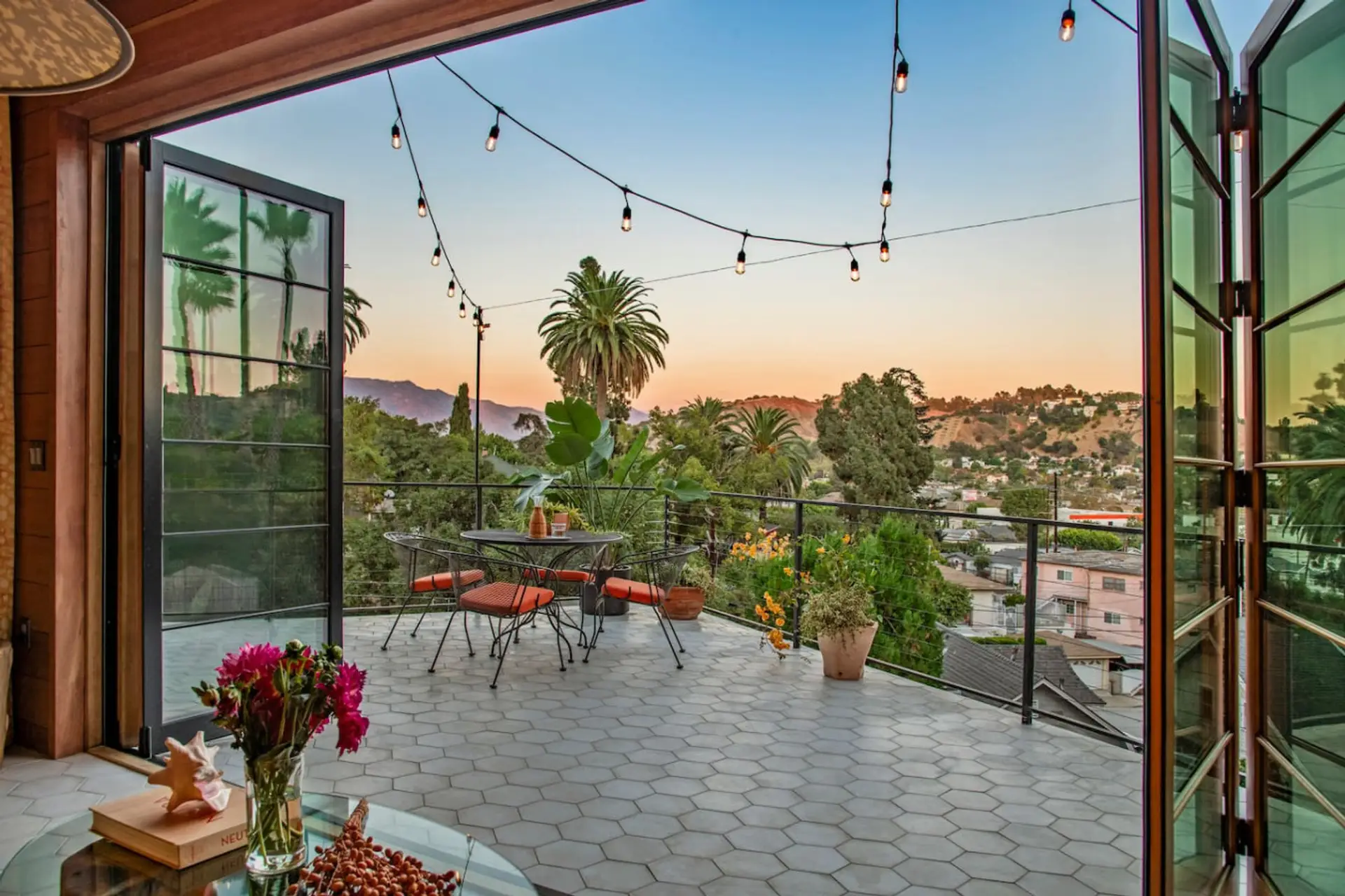 Step outside to a peaceful patio surrounded by citrus trees and hillside greenery.