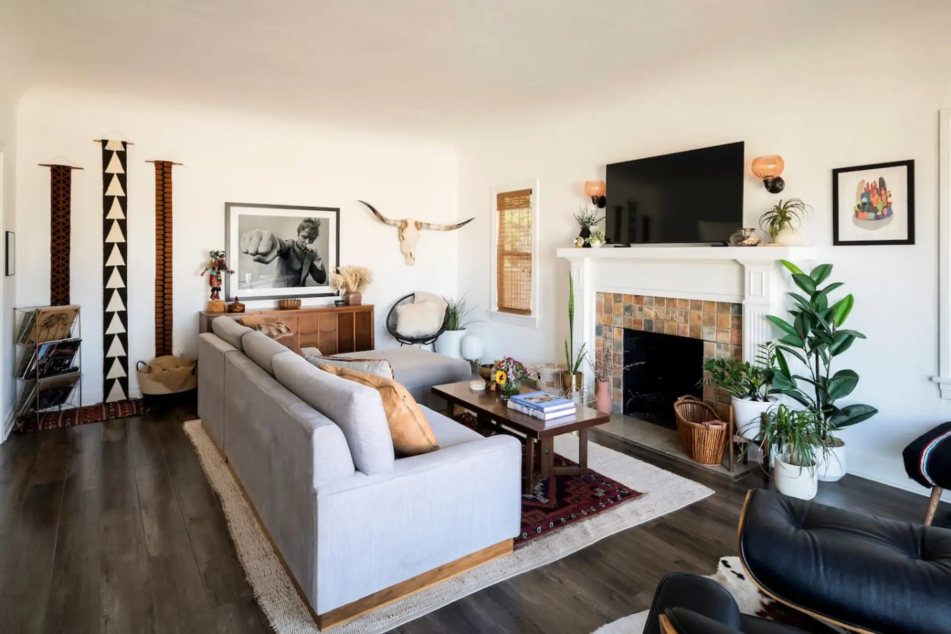 A warm, inviting living space with a plush sectional, non use fireplace, and thoughtfully curated design.