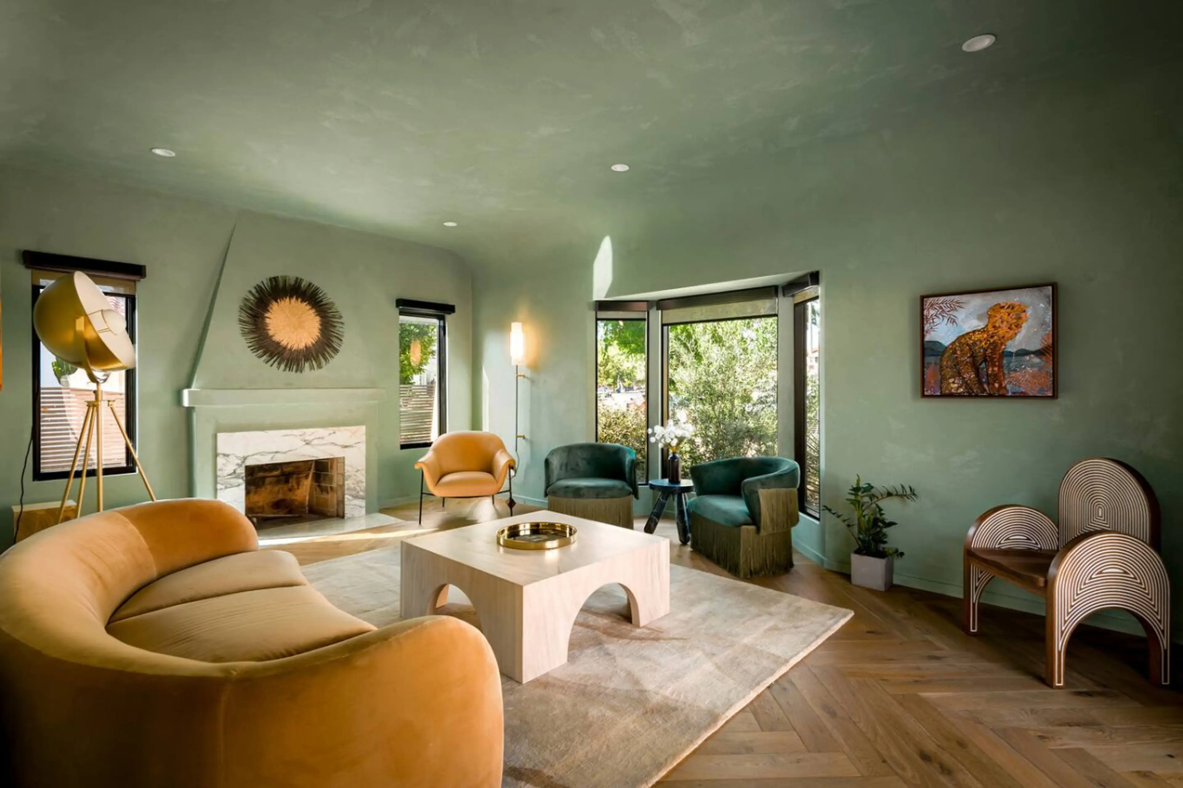 Open living space filled with natural light and anchored by a bold arched feature wall.