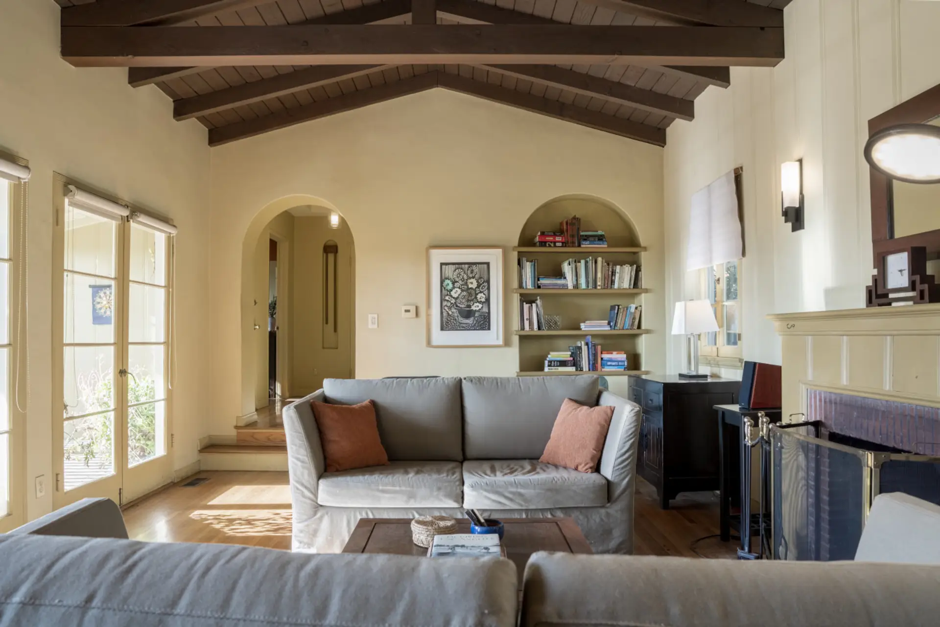 Open, airy layout with beamed ceilings and French doors that bring in natural light — a great space to settle into for a longer stay.
