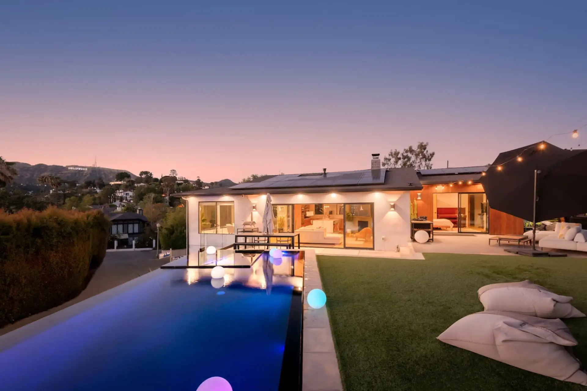 Stunning sunset view over the pool and outdoor lounge, perfect for relaxing evenings