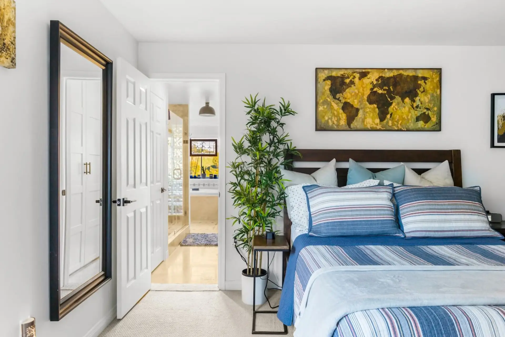Clean lines, bold art, and a comfortable king bed — the primary suite is designed for a good night's sleep and a great morning.