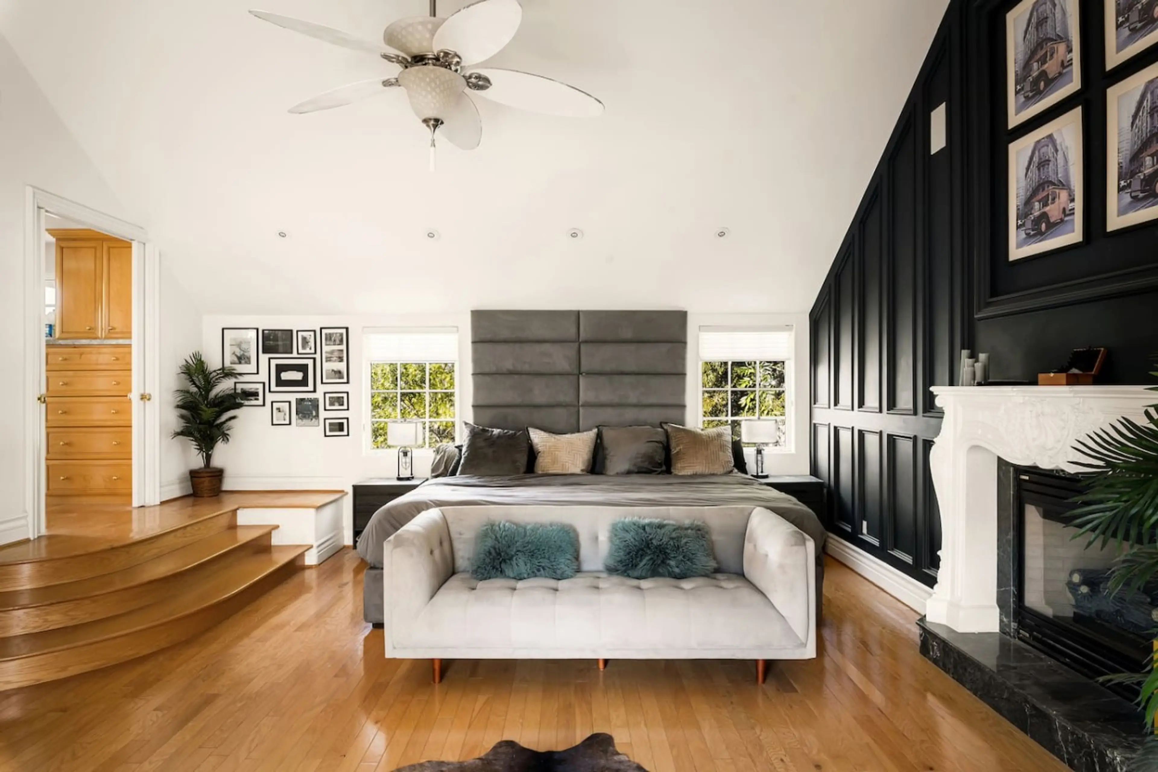 Primary suite with custom Alaskan king bed, fireplace, and designer finishes.