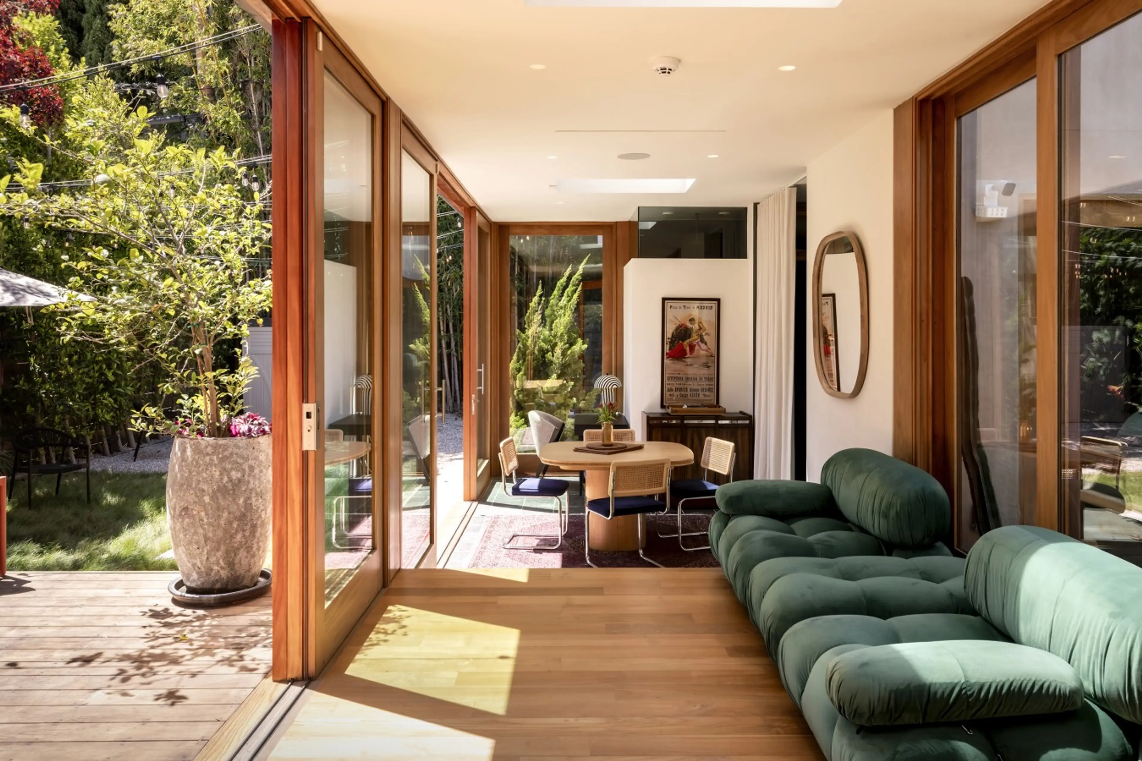 Patio doors frame a lush backyard view from the interior, with the dining area just steps away — a seamless connection between inside and out.