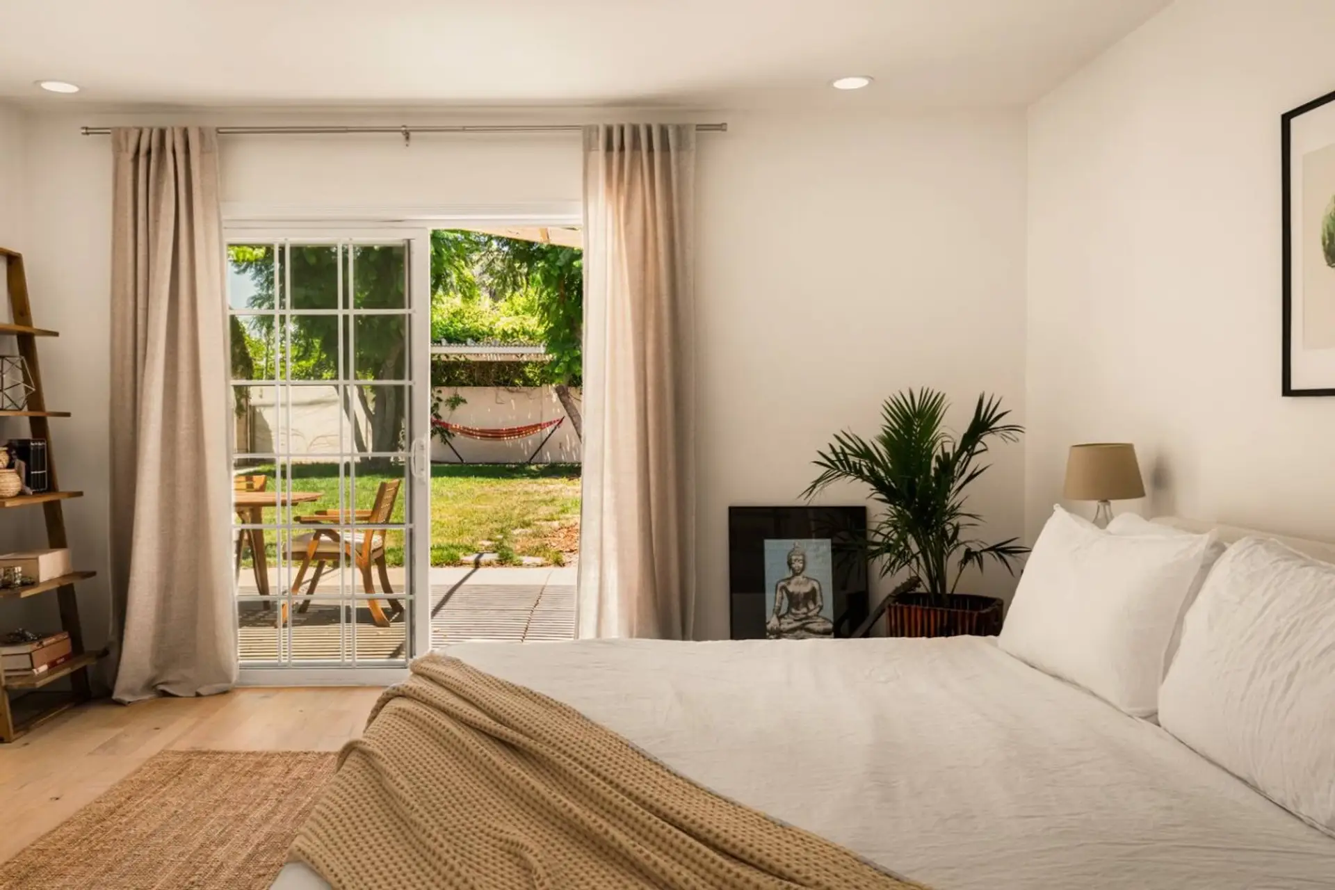 Bright and peaceful bedroom with direct access to the patio and garden.