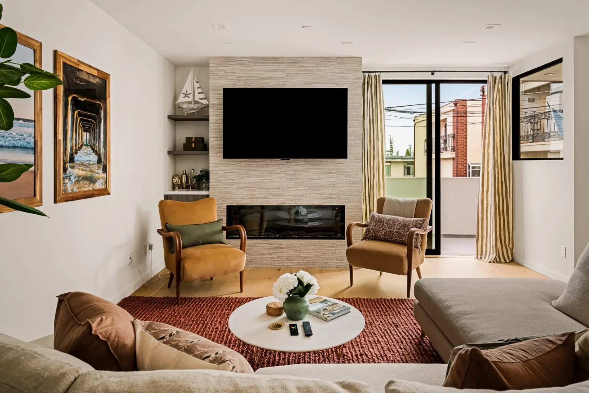 Bright, open, and welcoming, the living room offers plush seating, warm natural finishes, and abundant natural light. Seamlessly connected to the kitchen and dining area, it's an inviting space to relax and unwind.