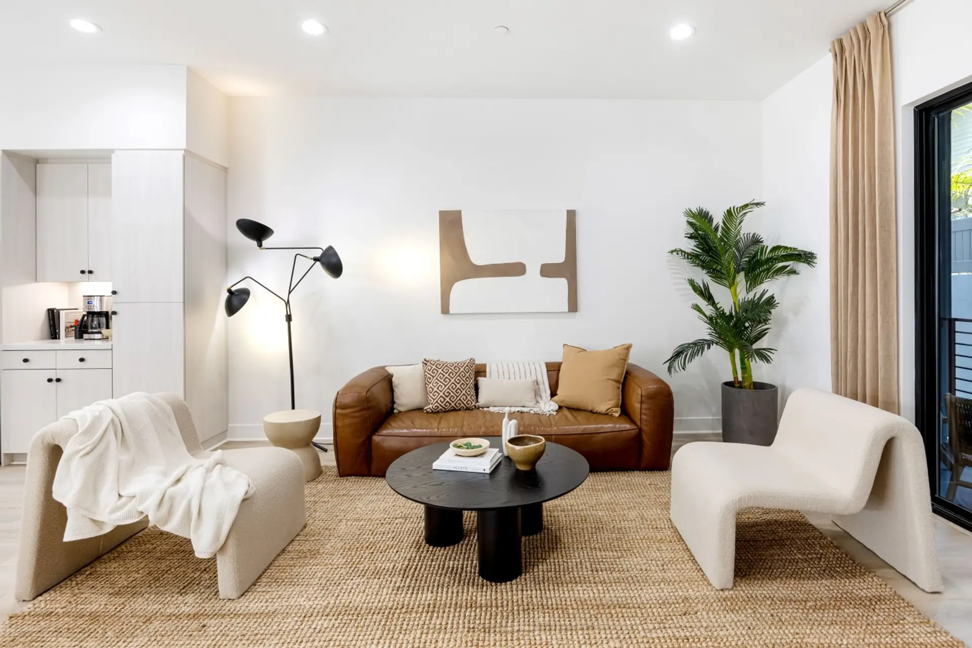 Warm, stylish living room with a leather sofa and cozy accent chair, a great spot to unwind after a day out.