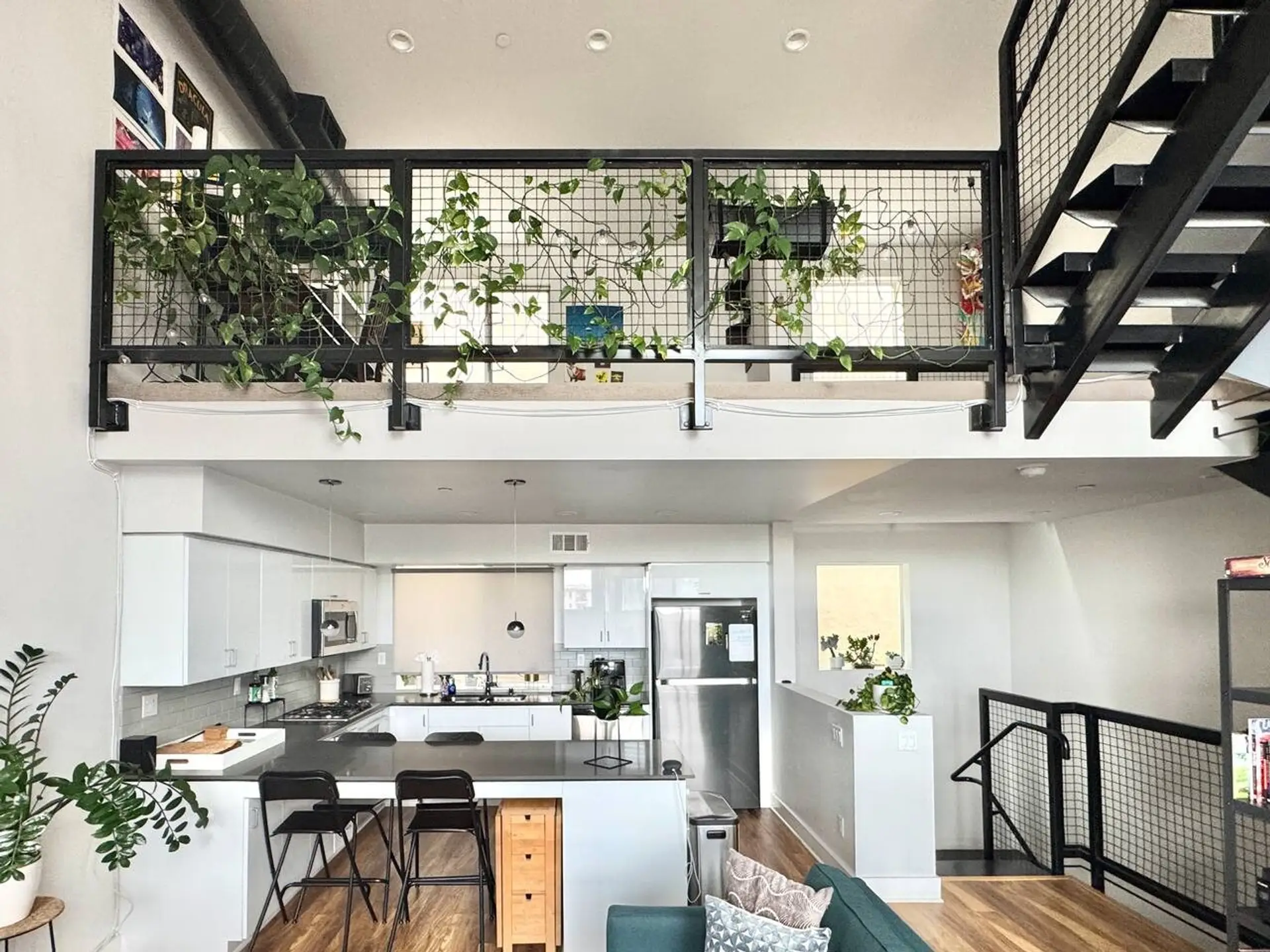 An open loft layout with greenery overhead, giving the whole space room to breathe.