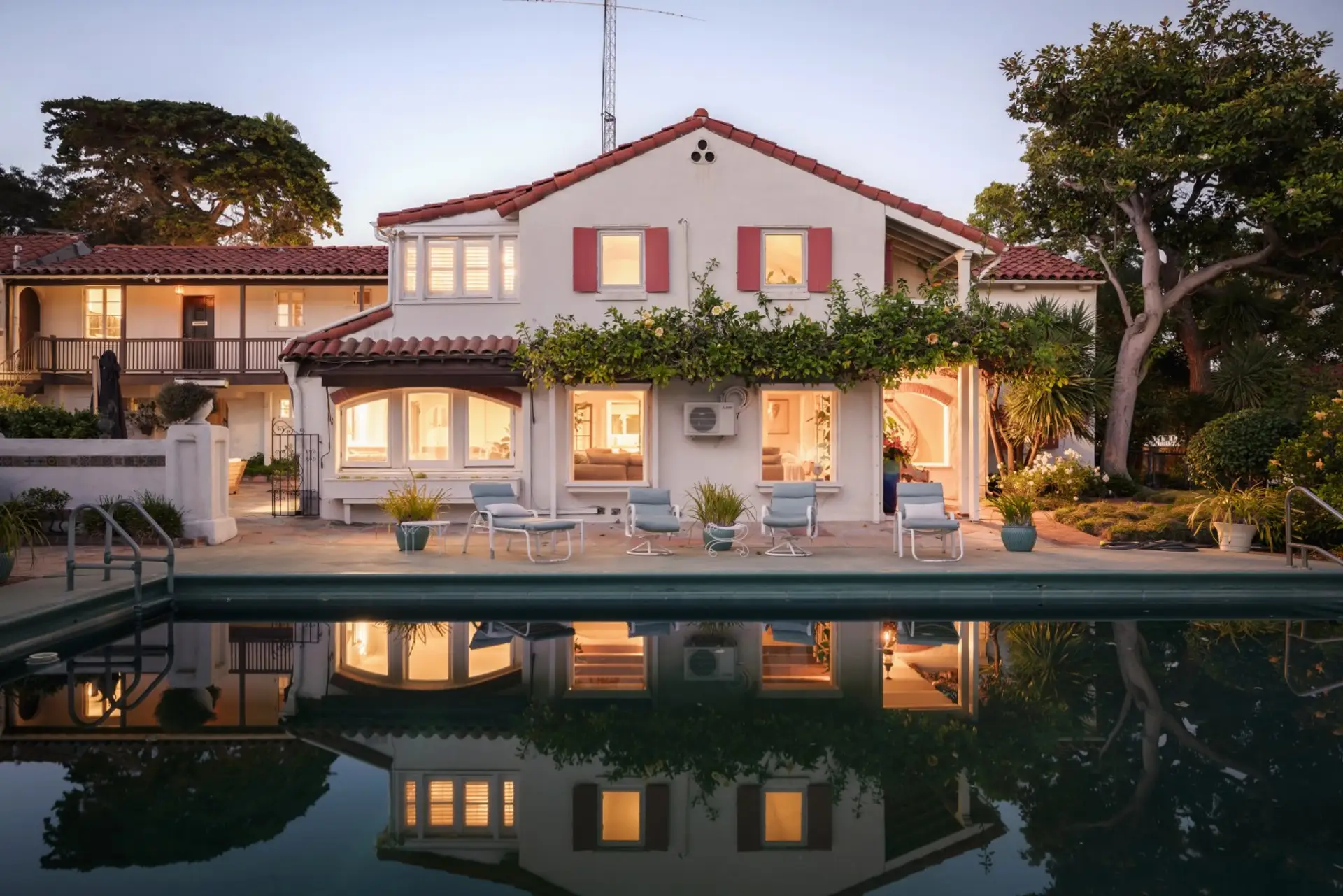 Twilight views of the pool and Spanish-style facade