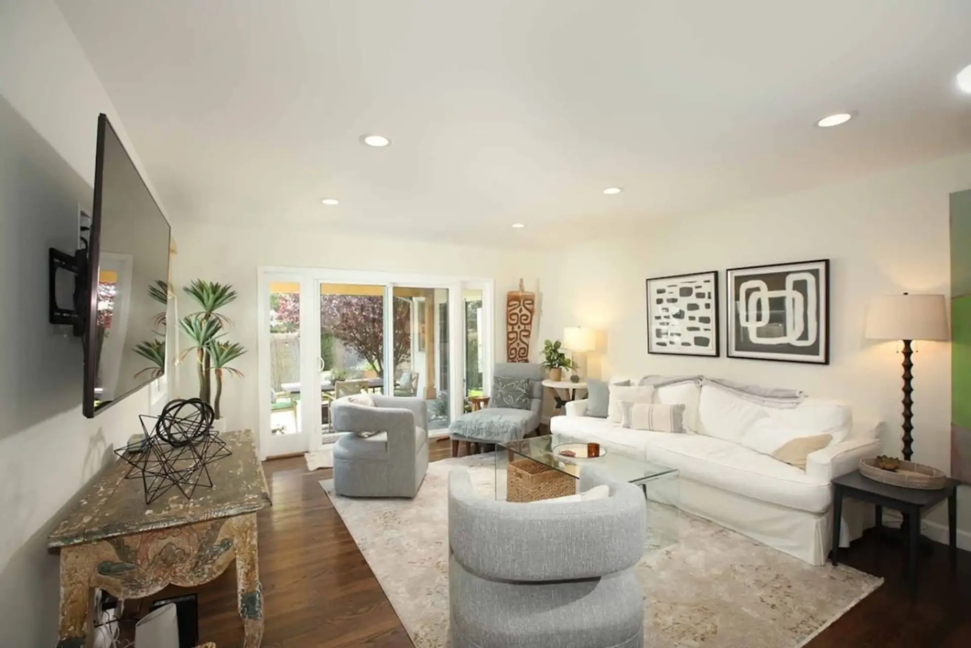 Sink into the front living room, framed by views of the grassy yard, mature trees, and citrus.