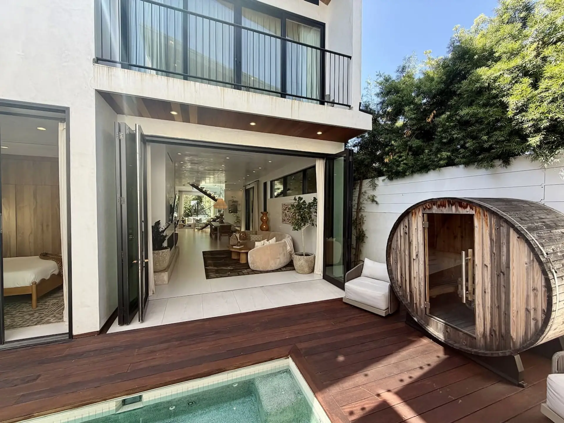 Floor-to-ceiling windows fill this cozy lounge with natural light and a view straight out to the pool deck.