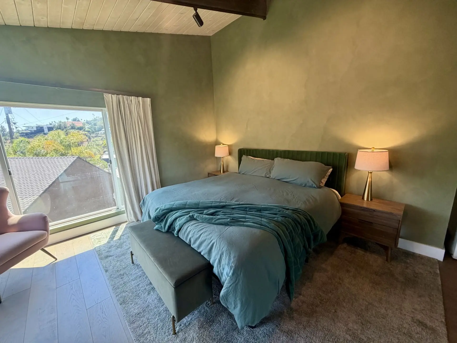 A restful bedroom retreat with warm lighting and hill views.