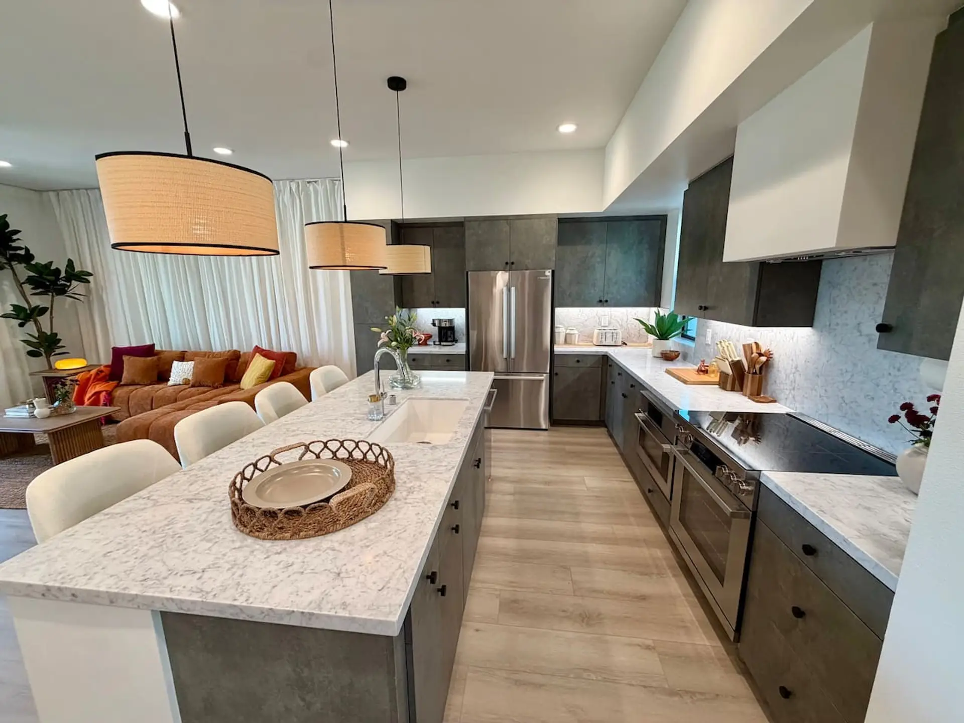 Dark cabinetry, marble countertops, and a full range of stainless appliances make this kitchen ready for everyday cooking or entertaining.