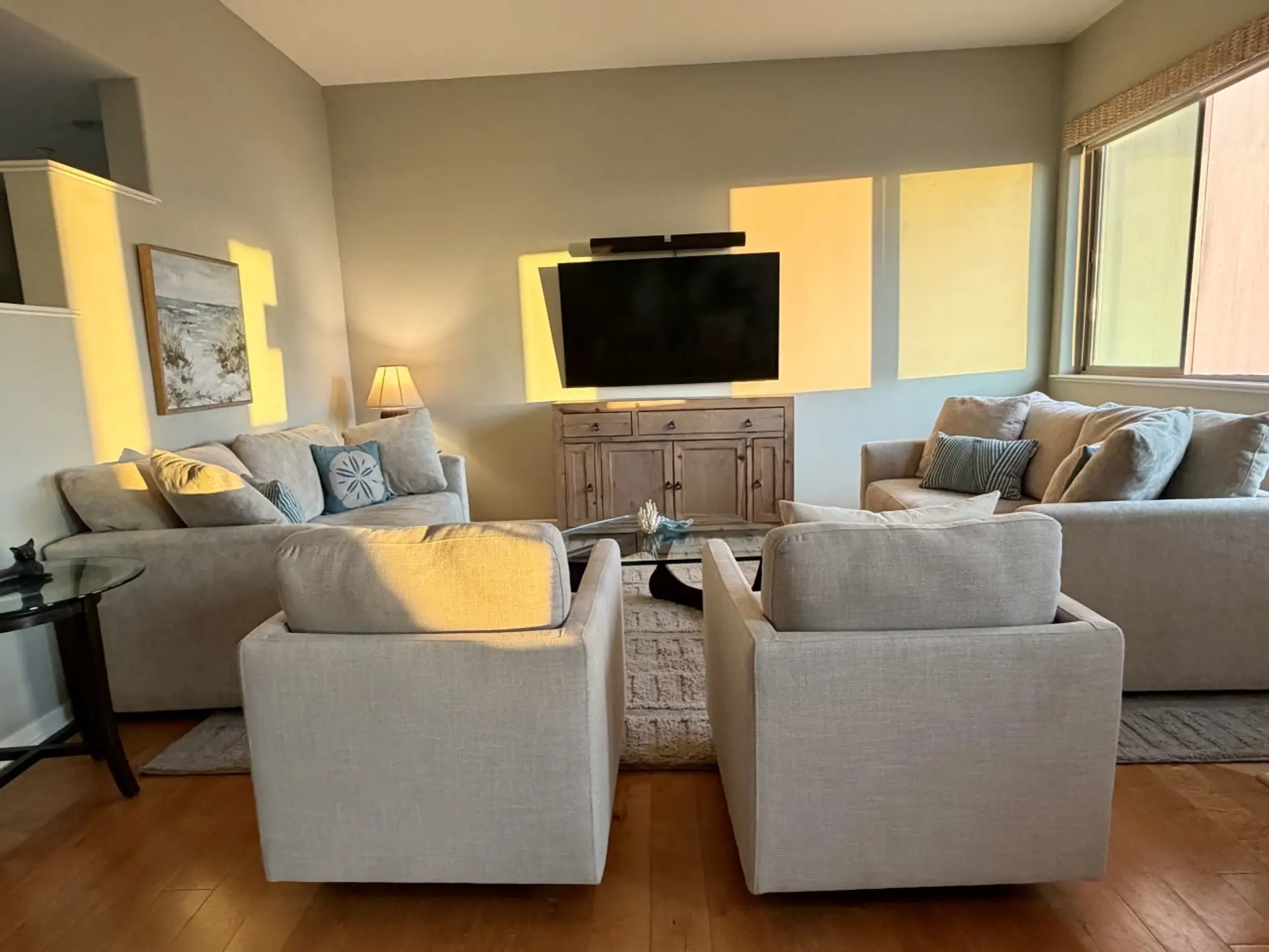 A bright, comfortable living space framed by large windows.